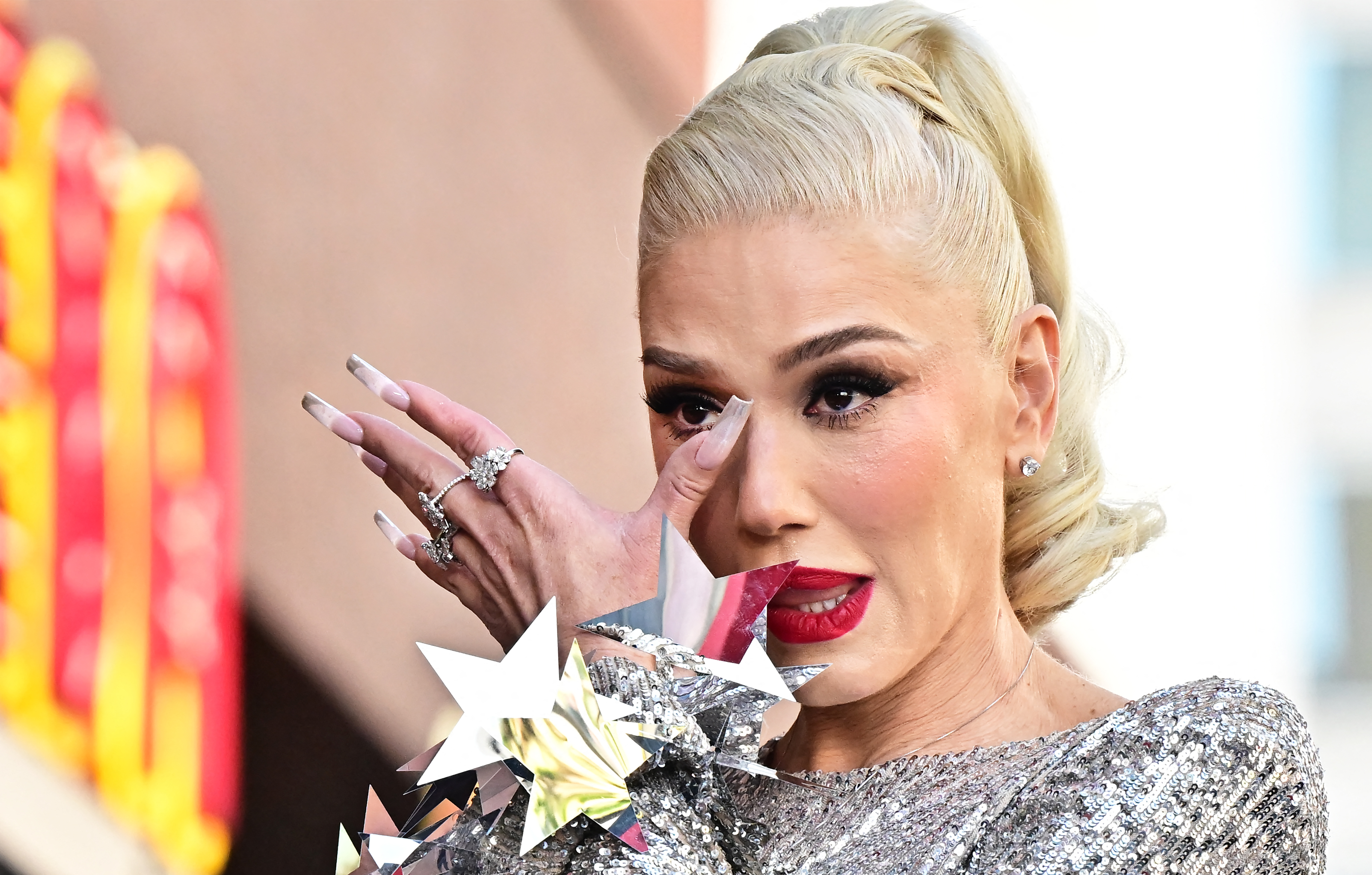Gwen Stefani wipes tears from her eyes during her Hollywood Walk of Fame Star ceremony in Hollywood, California, on October 19, 2023. | Source: Getty Images