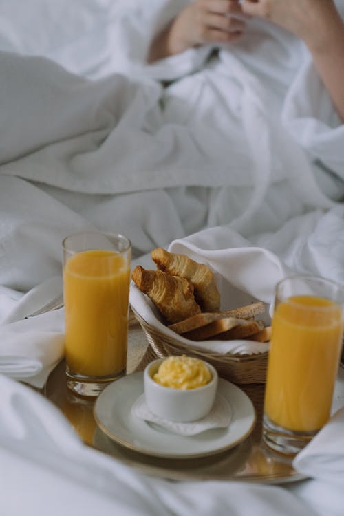 Juice and pastries served in bed | Source: Pexels