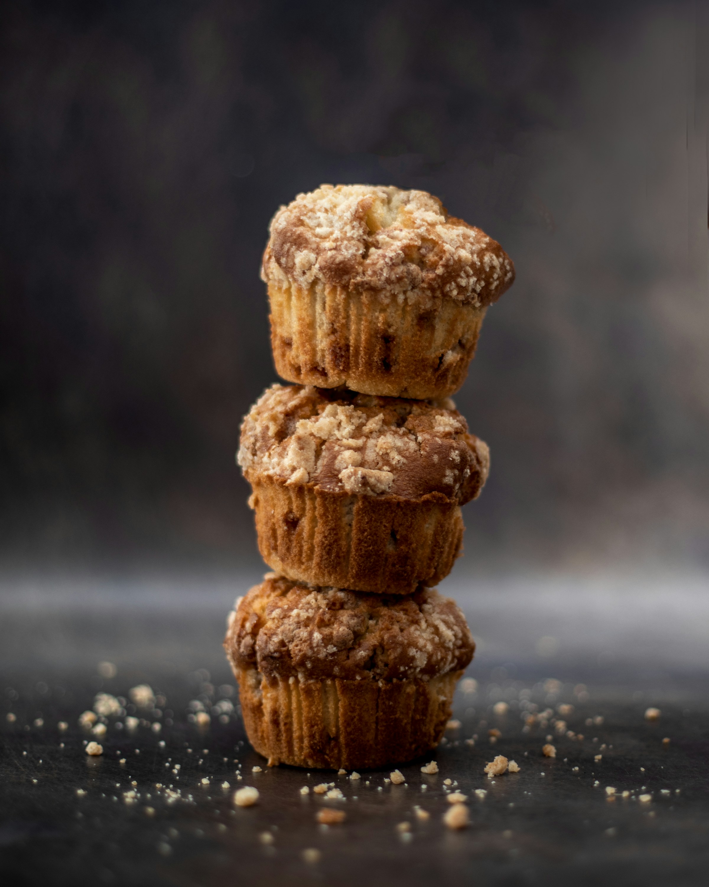 A stack of three muffins sitting on top of a table | Source: Unsplash