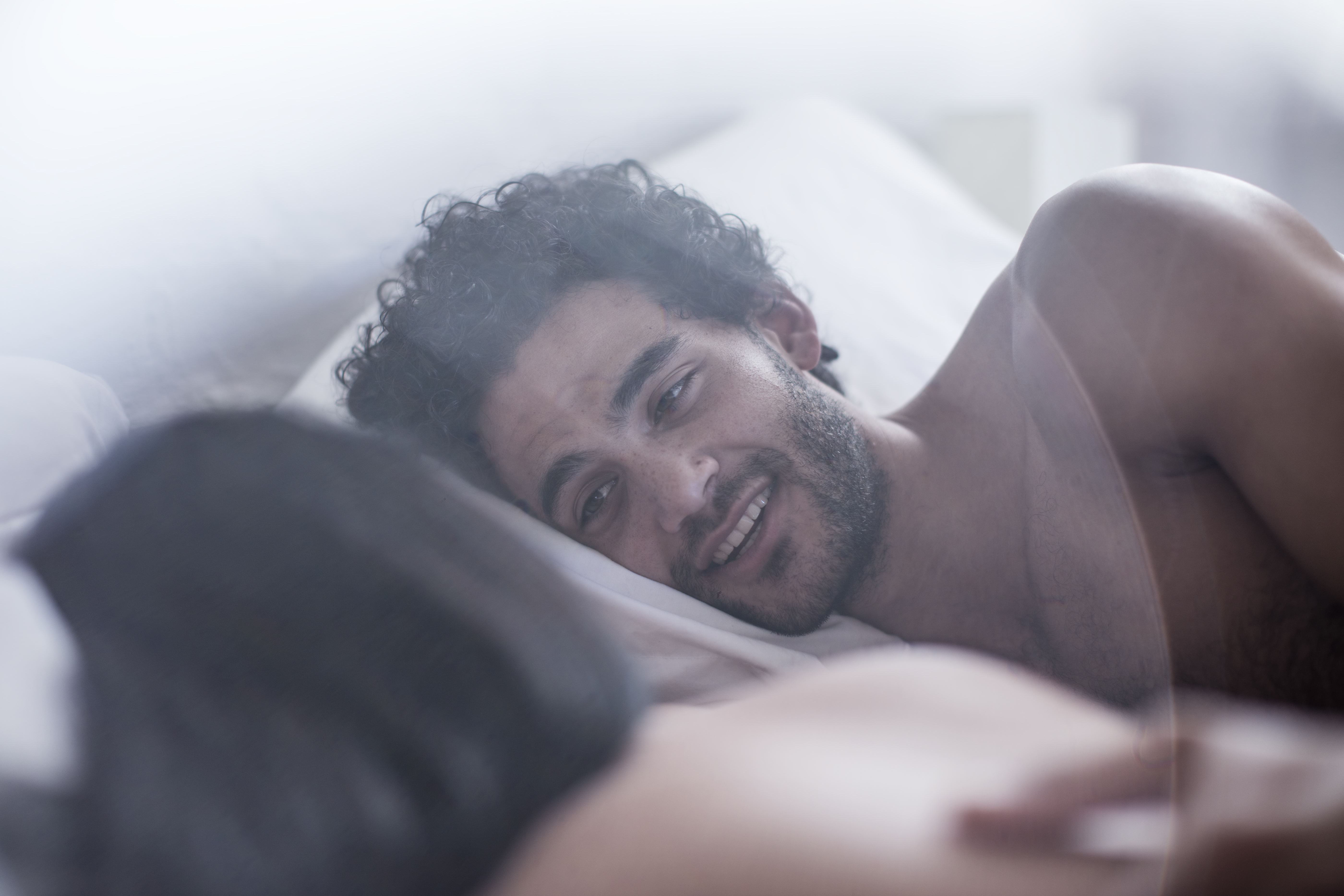 Young couple lying in bed