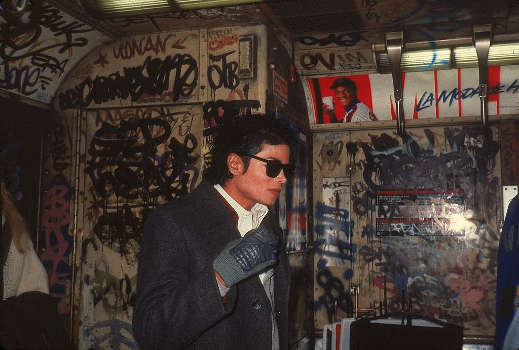 American musician Michael Jackson (1958 - 2009) stands in a graffiti-filled subway car during the filming of the long-form music video for his song 'Bad,' directed by Martin Scorsese, New York, New York, November 1986. | Source: Getty Images