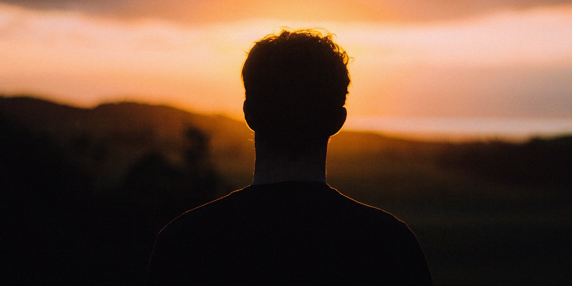 Unsplash | A man looking into the sunset
