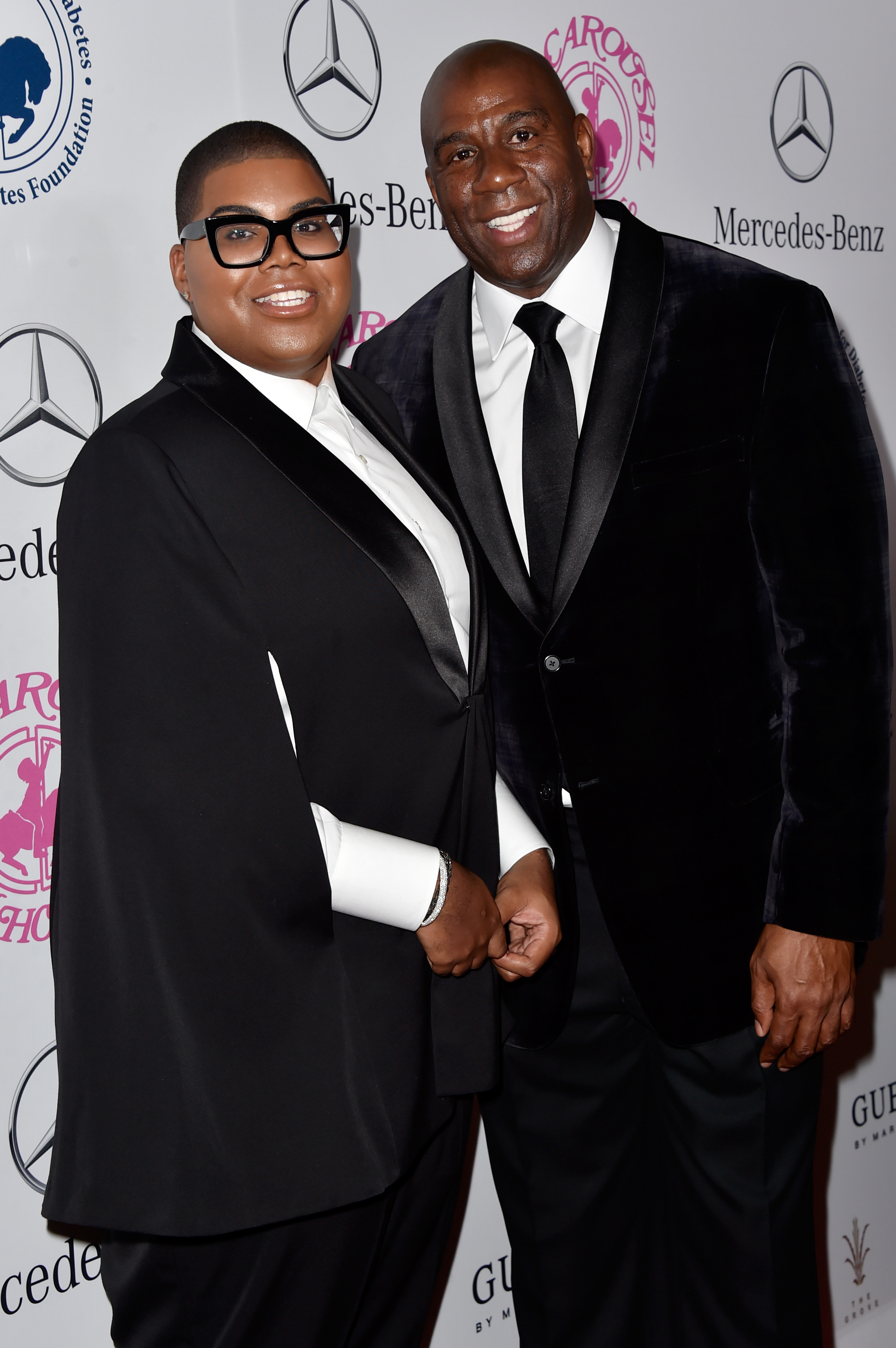 EJ and Magic Johnson strike a stylish pose at the 2014 Carousel of Hope Ball. With polished tuxes and radiant smiles, the red carpet becomes a runway for legacy and elegance.