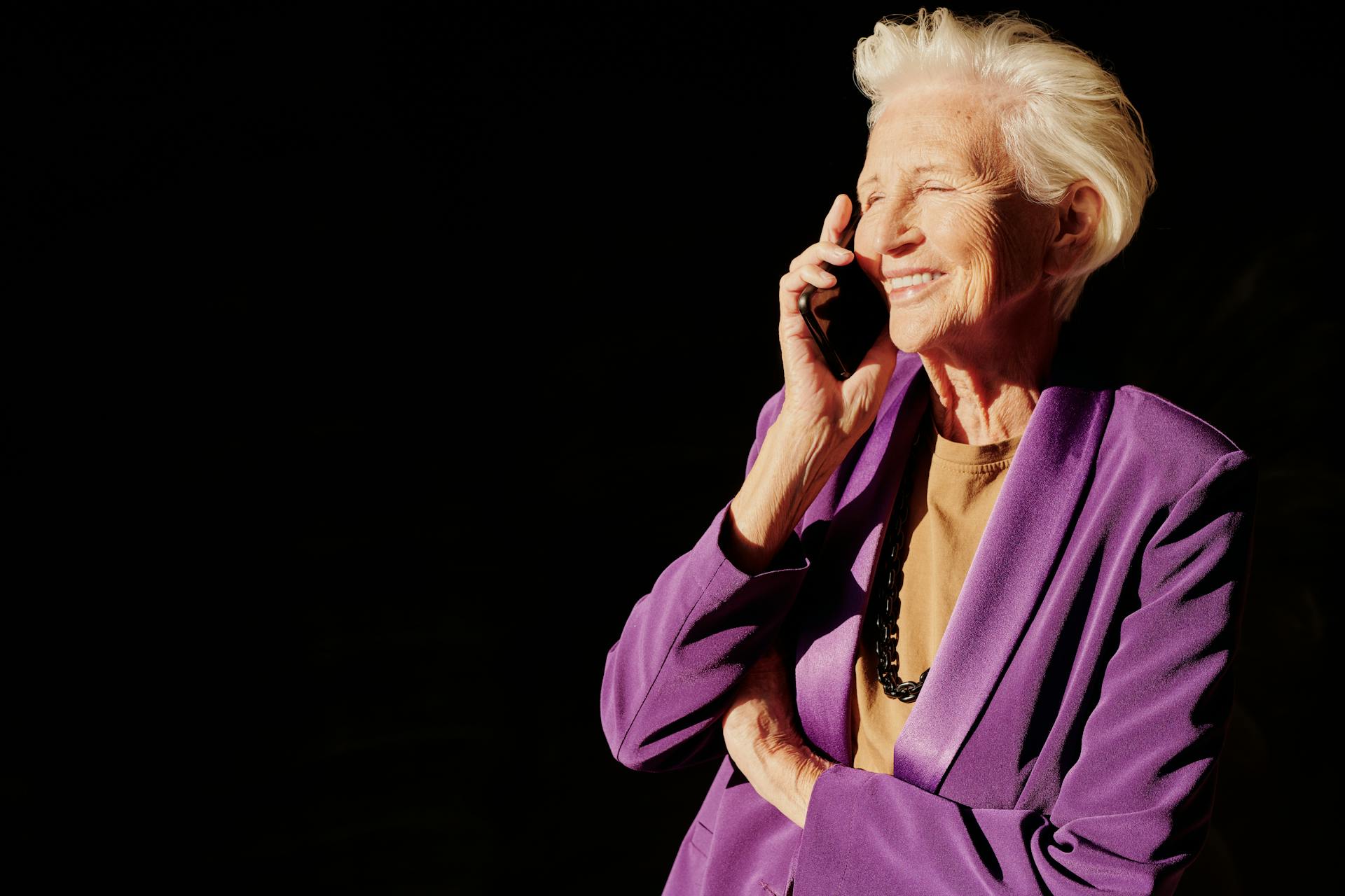 An elderly woman speaking on the phone | Source: Pexels