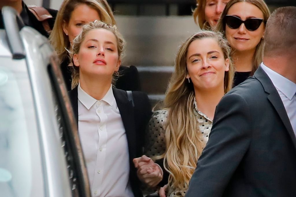 Amber Heard and Whitney Heard walking out of court in London, on July 24, 2020. | Source: Getty Images
