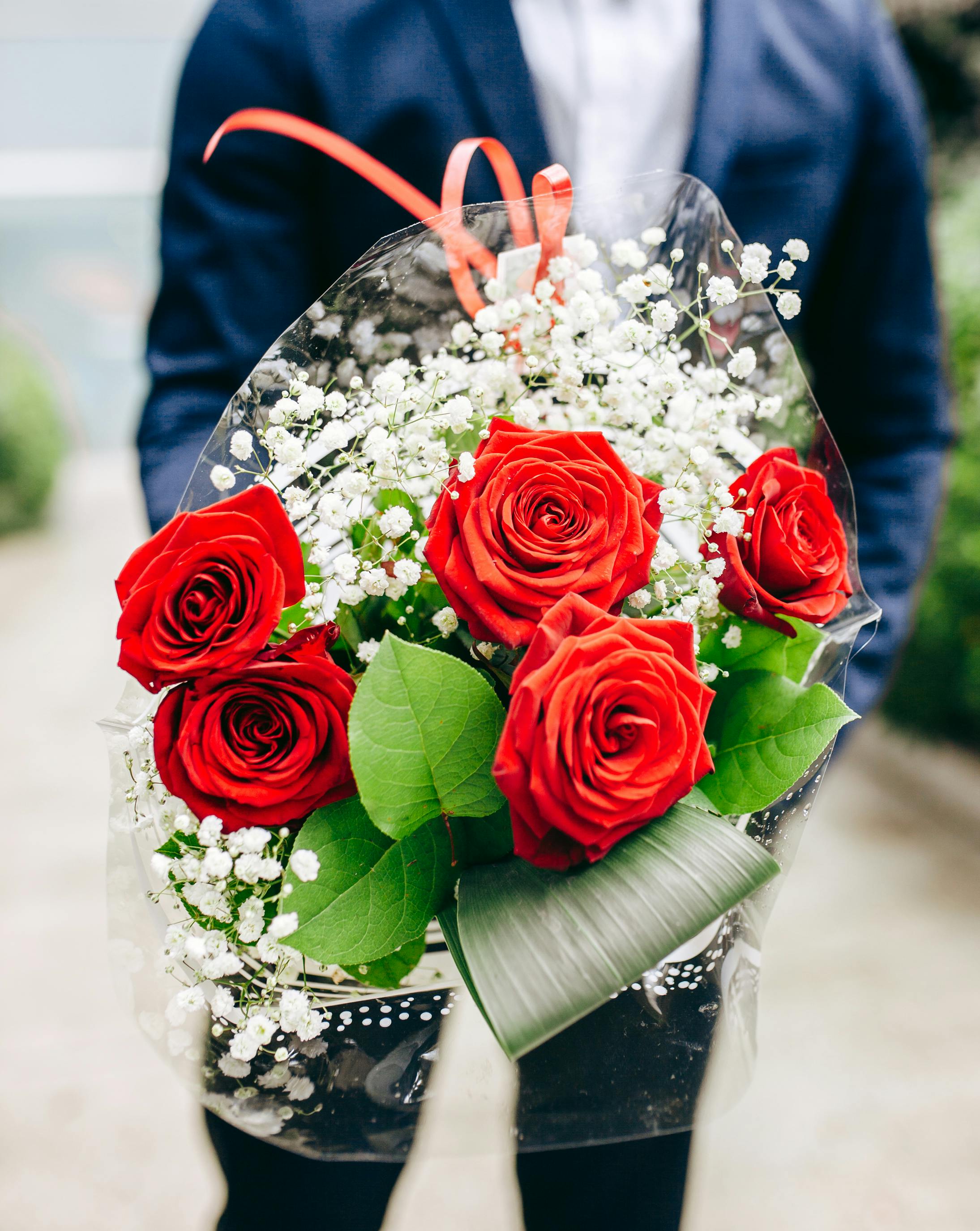 A man clutching a bouquet of flowers | Source: Pexels