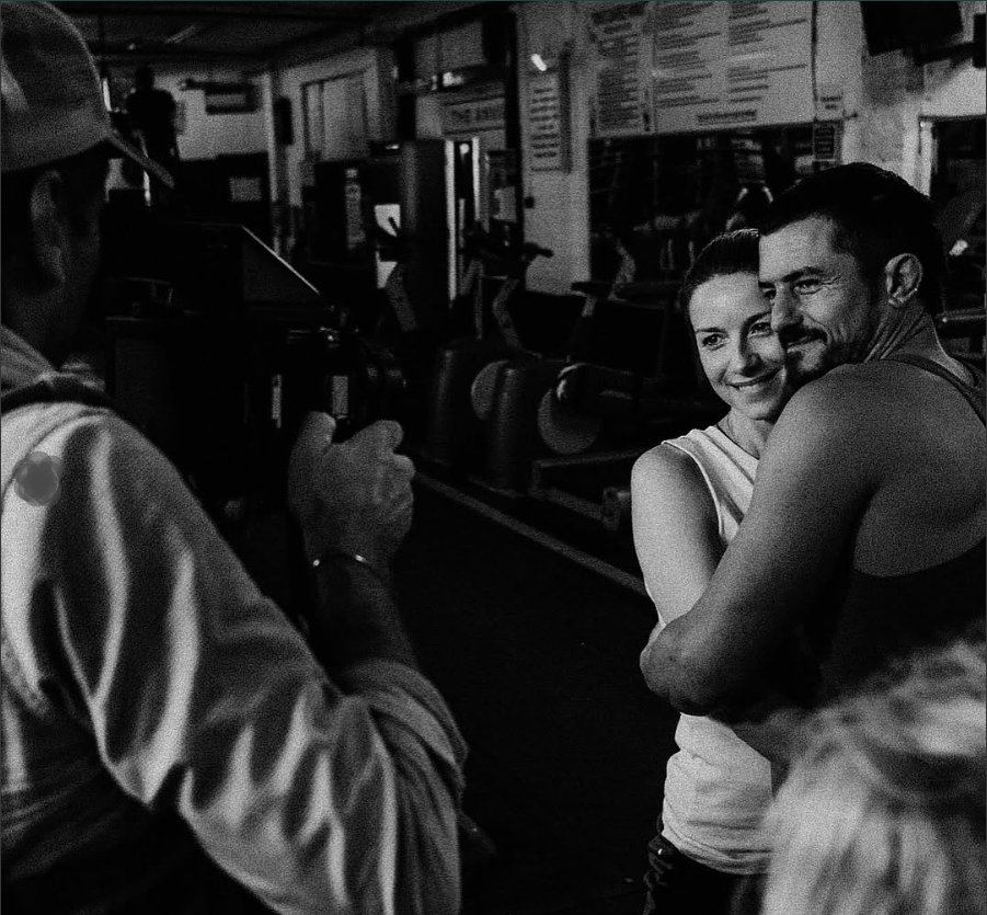 Orlando Bloom embraces another woman as seen in a post dated October 9, 2025 | Source: Instagram/seanellisphoto