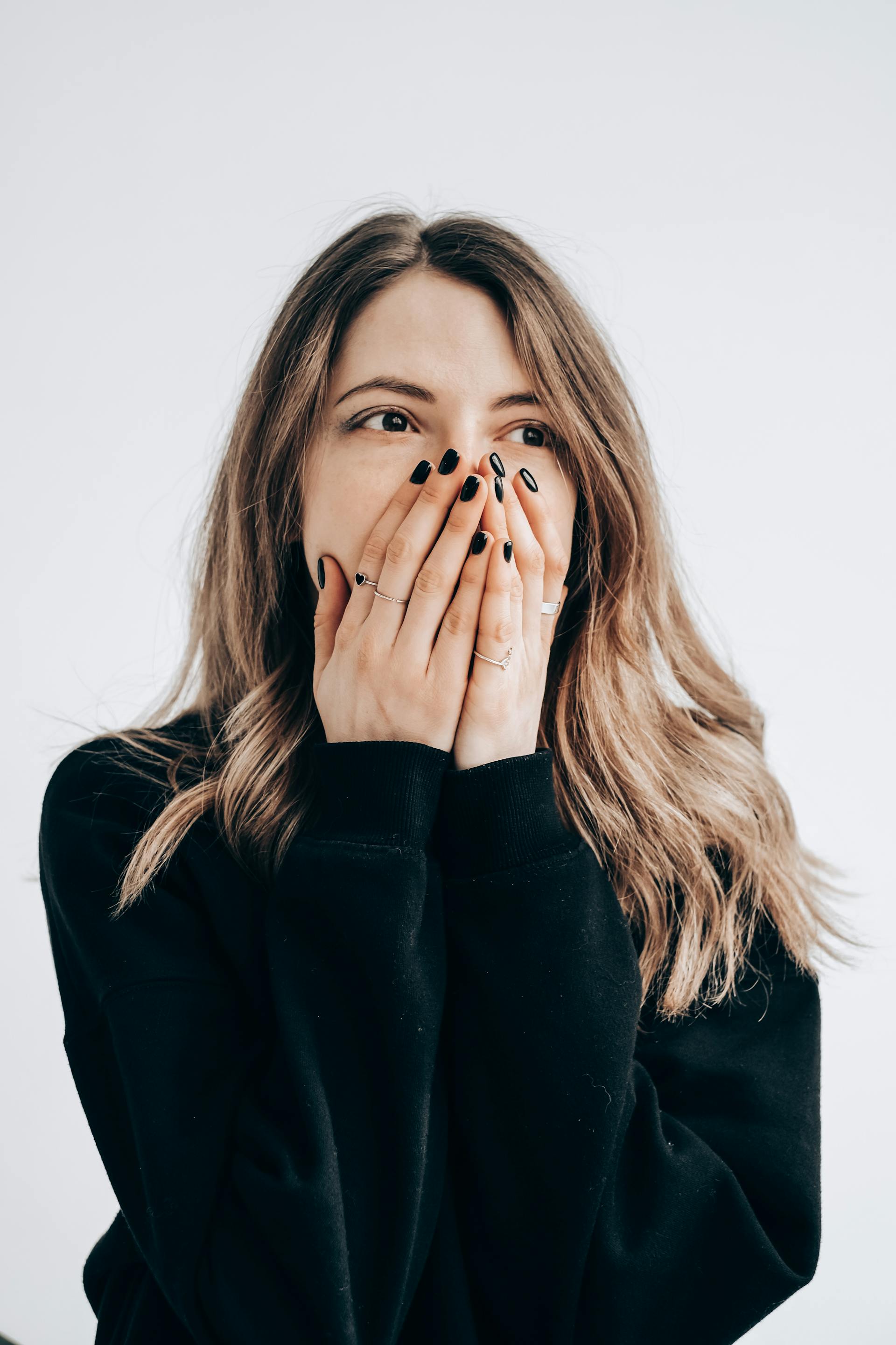 A stunned woman covering her mouth | Source: Pexels