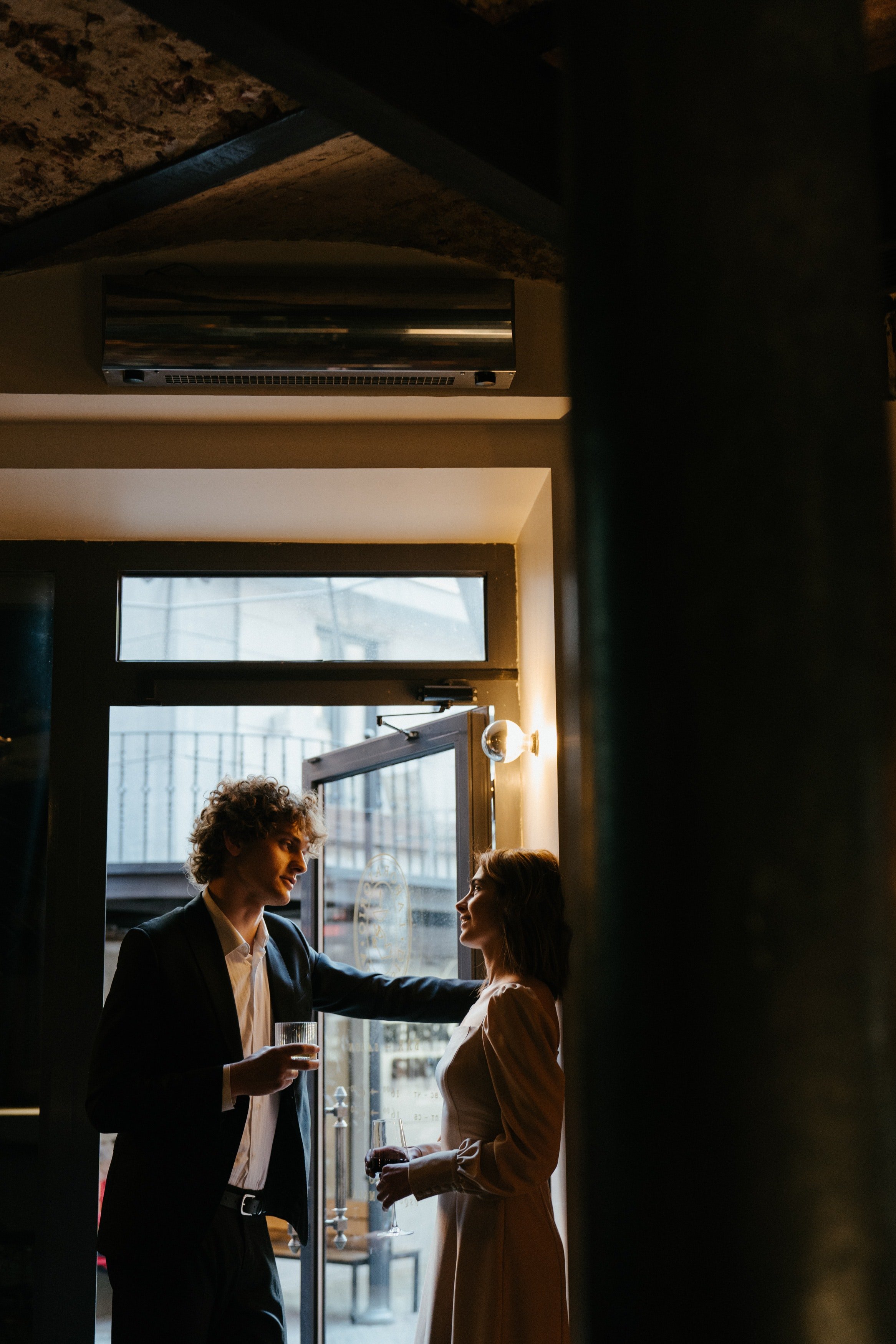 Man in black suit standing in front of a woman | Photo: Pexels