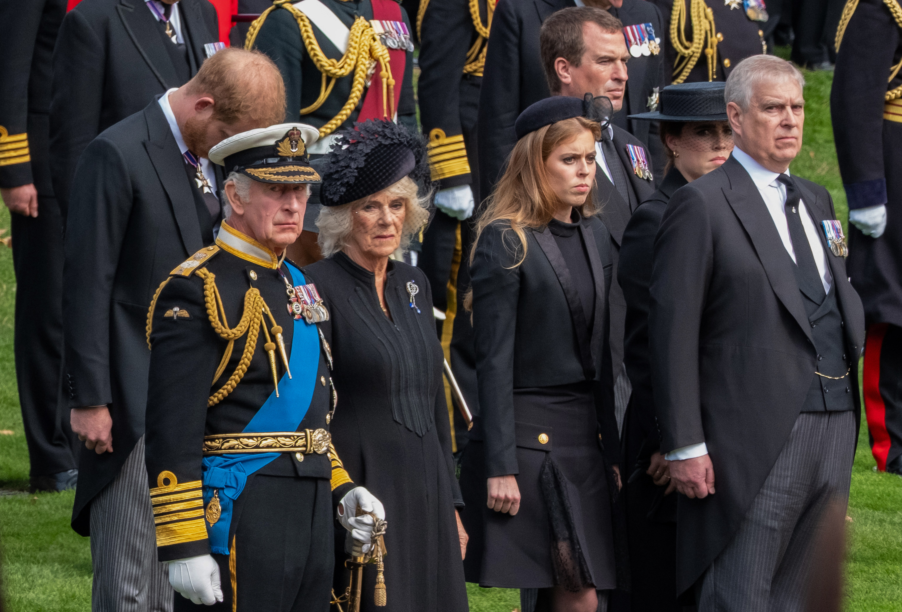 King Charles III, Queen Camilla, Prince Harry the Duke of Sussex, Andrew Mountbatten-Windsor with his daughters Princess Beatrice and Princess Eugenie, and Peter Phillips watch as the coffin of Queen Elizabeth II is carried by gun carriage to Wellington Arch from Westminster Abbey on 19 September 2022 in London, England. | Source: Getty Images