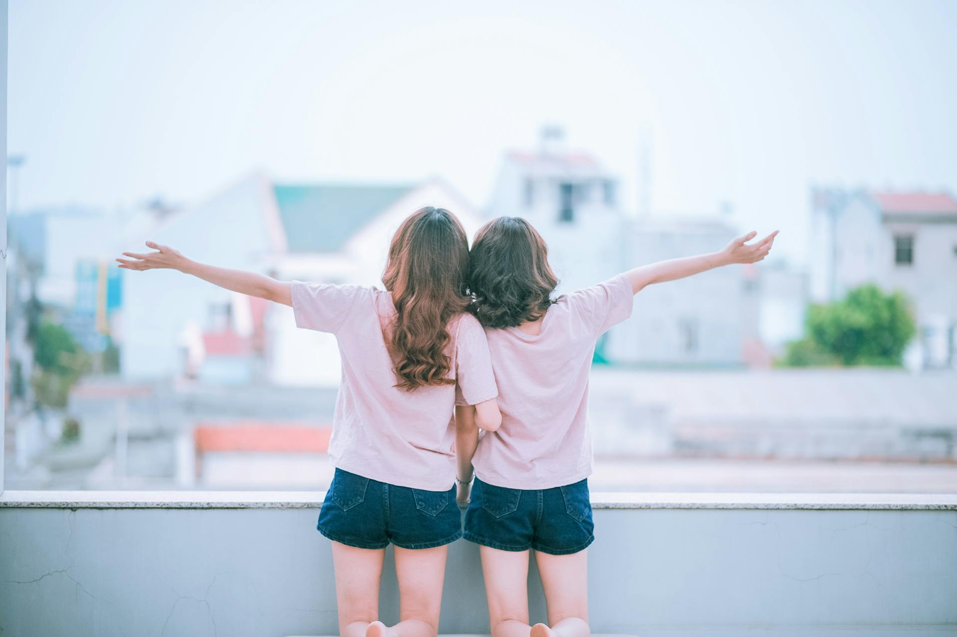 Two women wearing matching clothes on a balcony | Source: Pexels