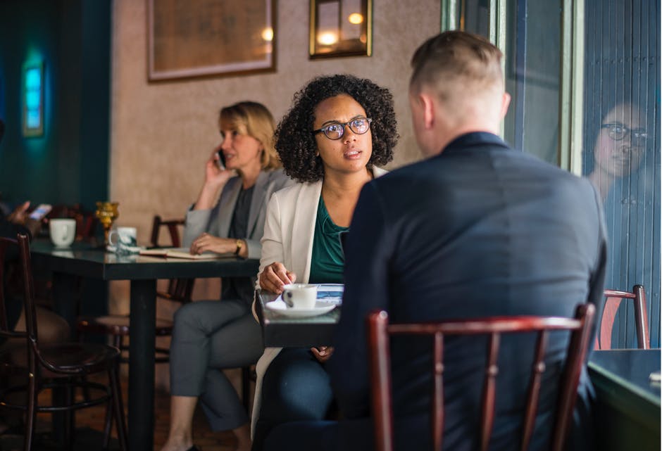 A woman looking at a man during a coffee date. | Source: Pexels