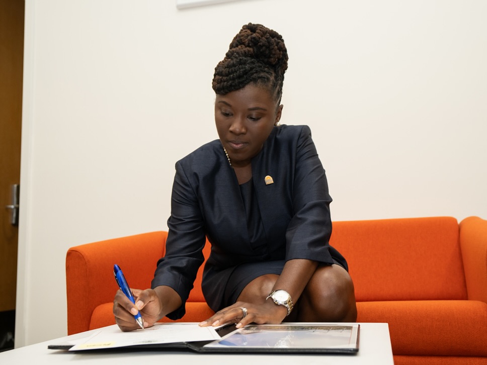 Nancy Metayer Bowen signing a document in a picture shared on December 31, 2024 | Source: Facebook/Nancy Metayer Bowen