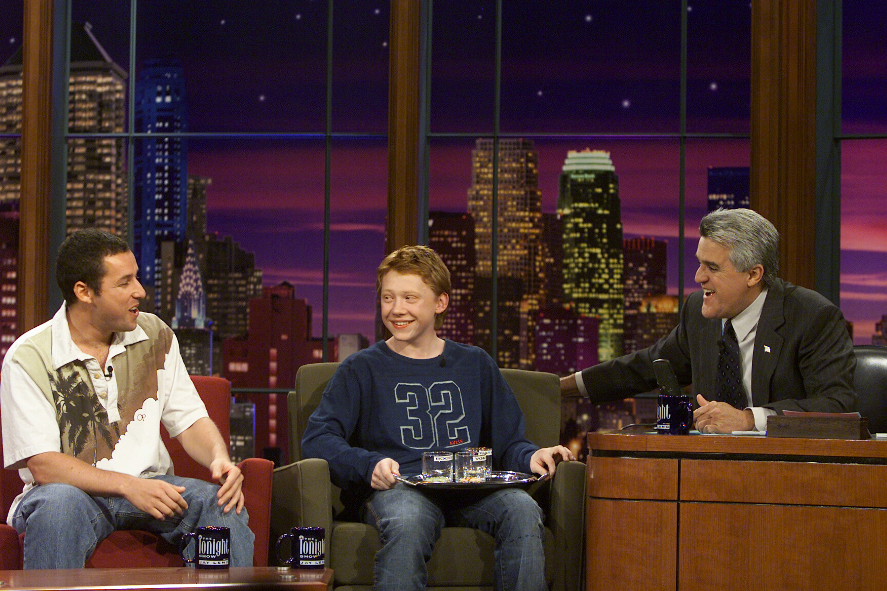 Adam Sandler and Rupert Grint during an interview with host Jay Leno on "The Tonight Show with Jay Leno" on November 13, 2002 | Source: Getty Images