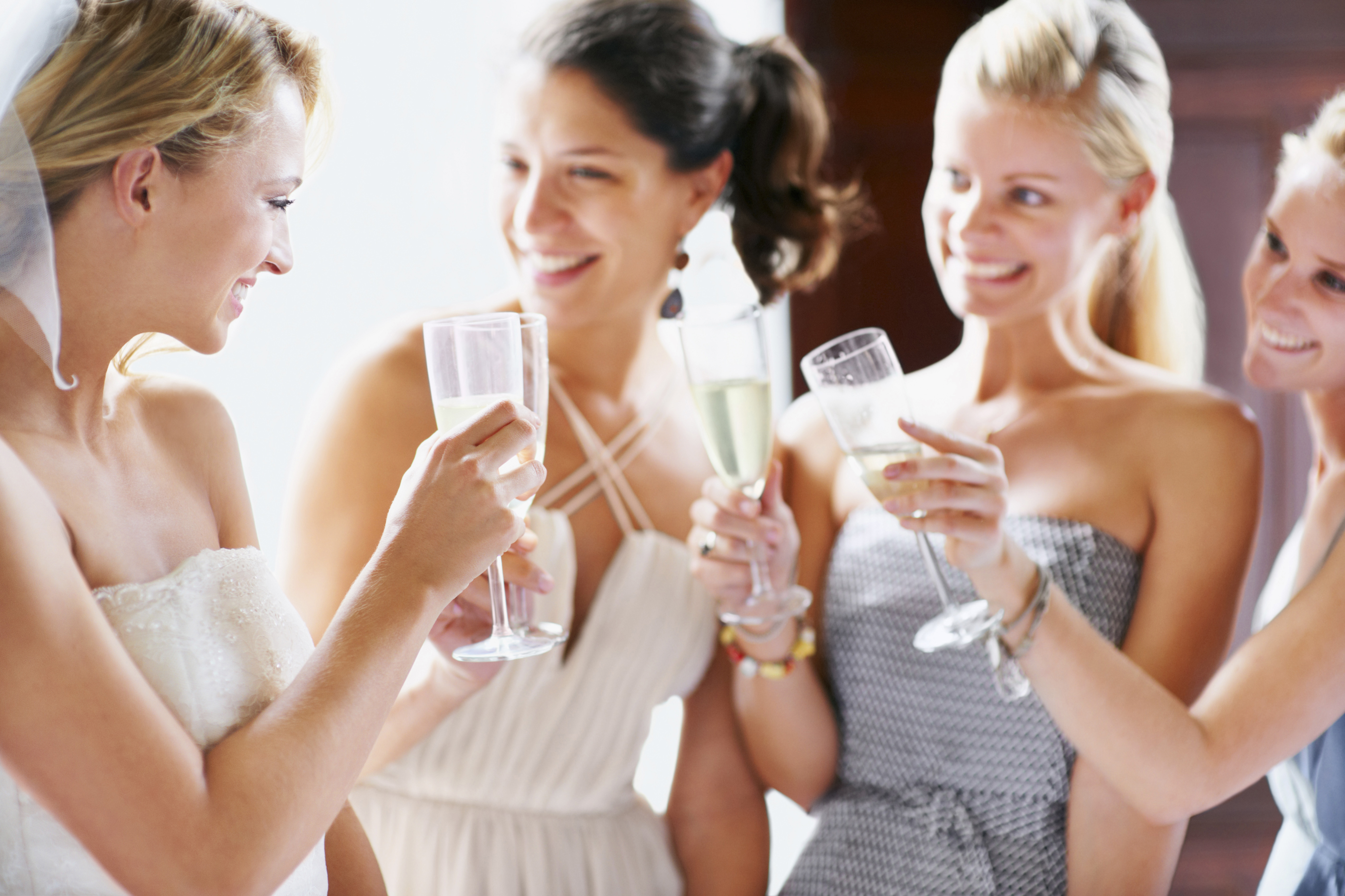 Bride and bridesmaids toasting. | Source: Getty Images