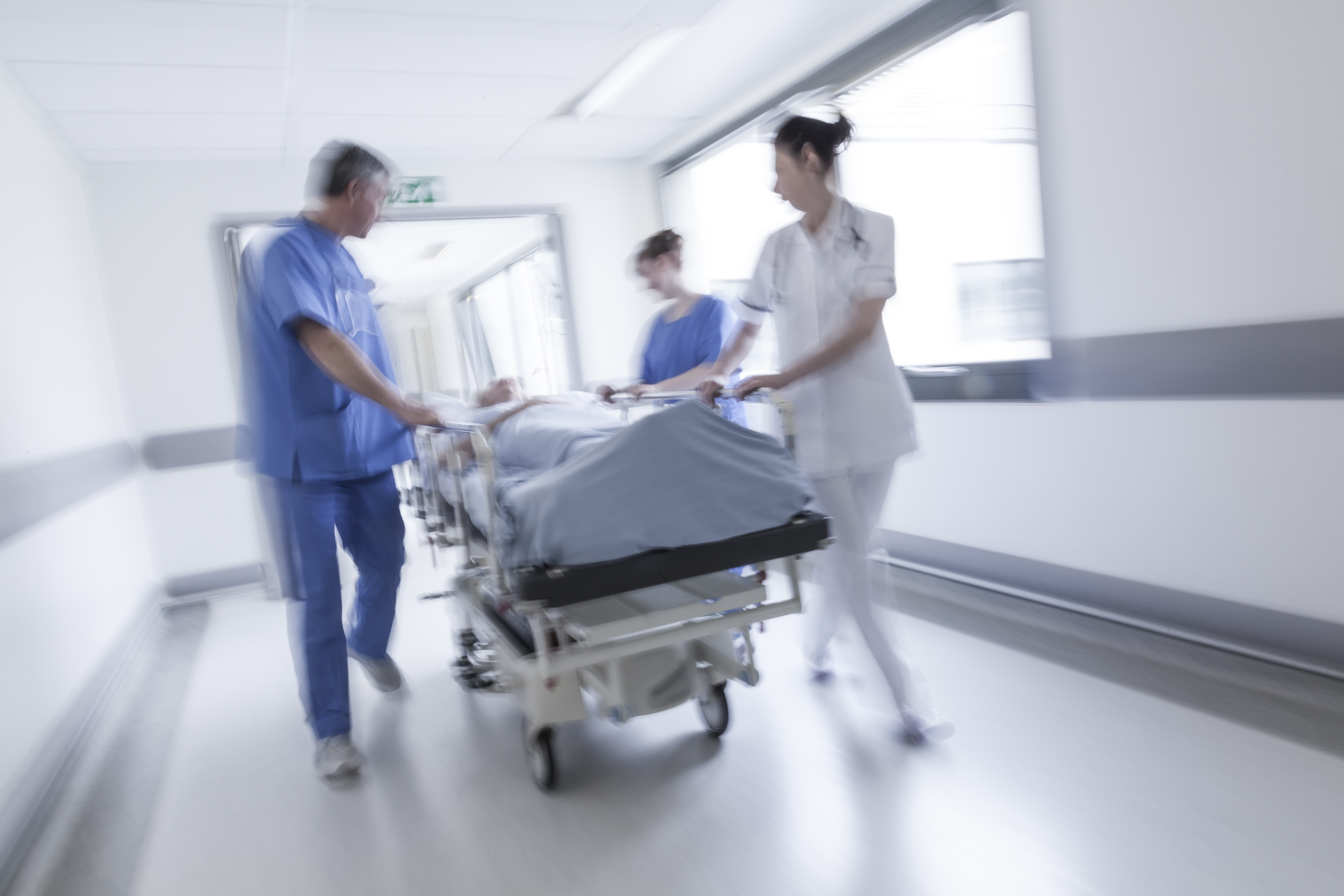 A patient on a stretcher surrounded by doctors in the hospital | Source: Shutterstock