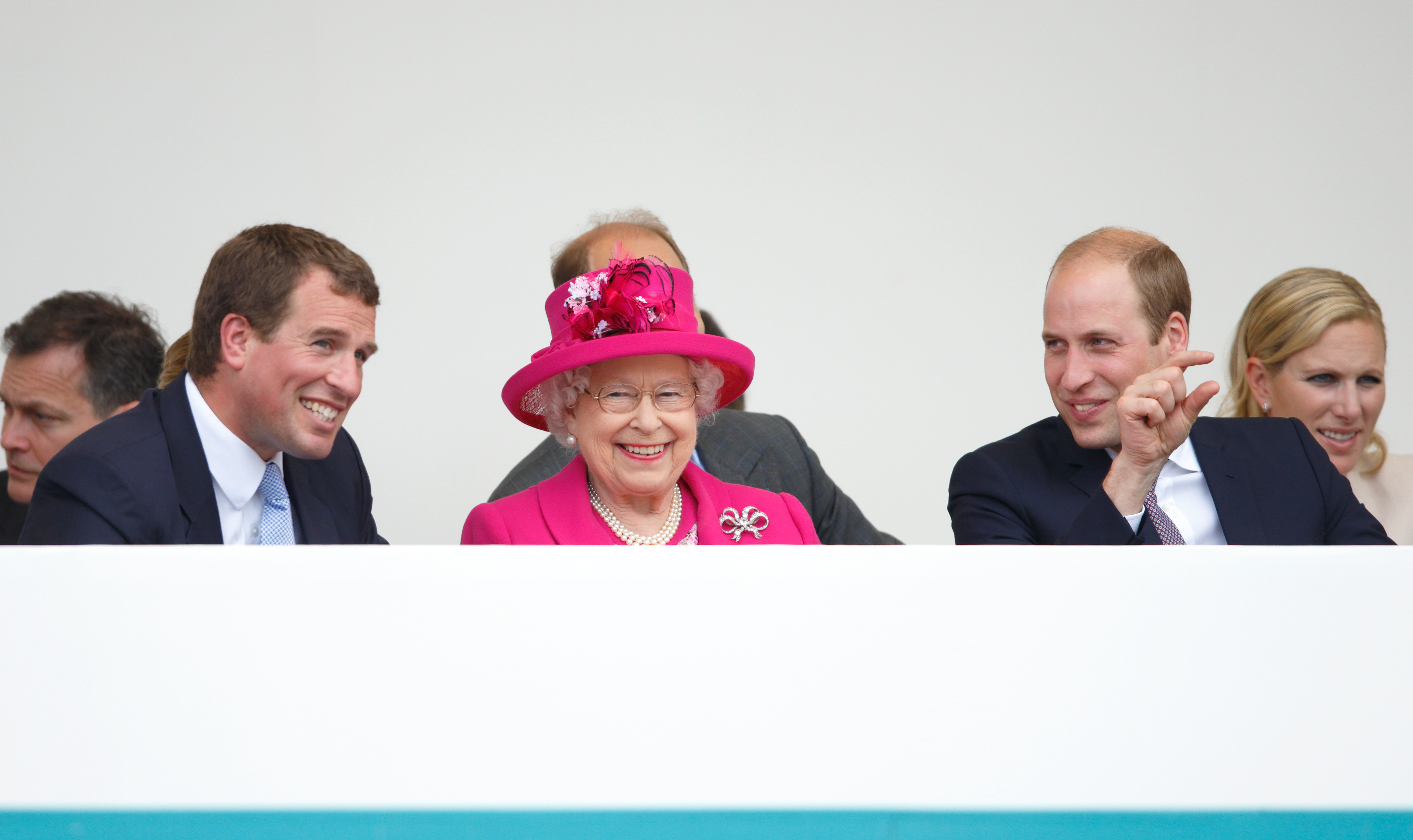 Peter Phillips, Queen Elizabeth II and Prince William watching a carnival parade at 'The Patron's Lunch' celebrations to mark Queen Elizabeth II's 90th birthday on The Mall on June 12, 2016 in London, England | Source: Getty Images