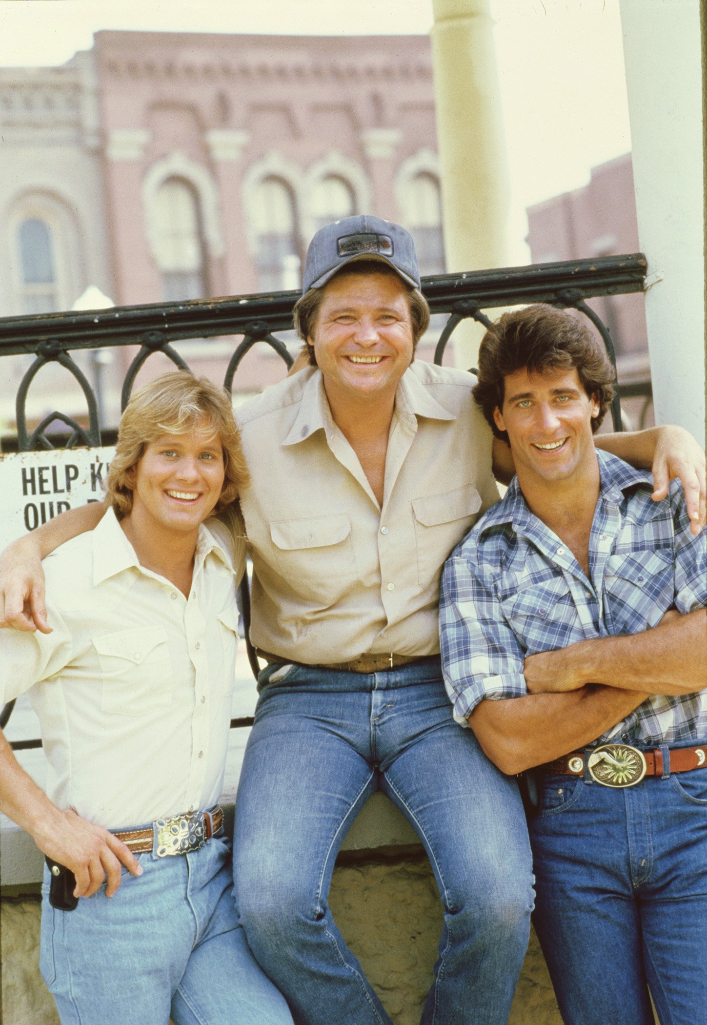 Byron Cherry (as Coy Duke), Ben Jones (as Cooter Davenport) and Christopher Mayer (as Vance Duke) on the set of the television series "The Dukes of Hazzard," in August 1982. | Source: Getty Images.