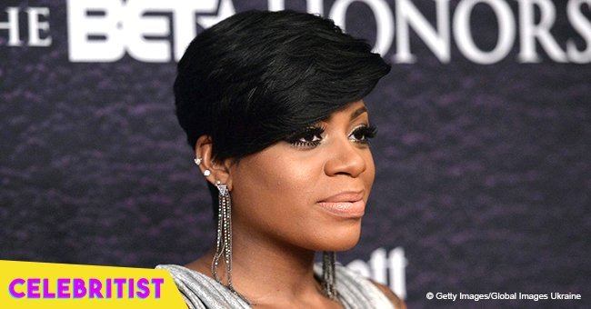 Fantasia stuns in colorful maxi dress with slit & black hat in recent video