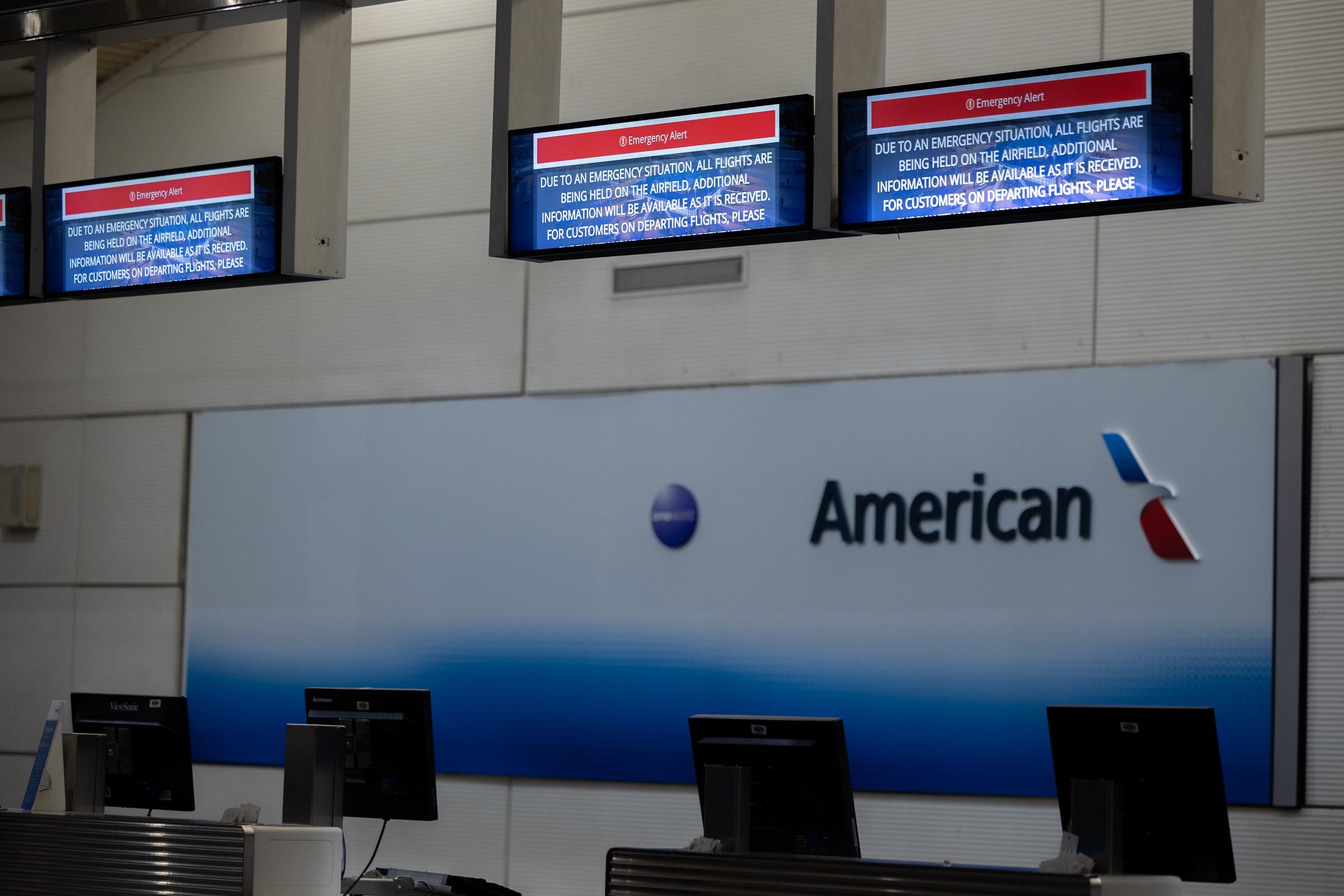 The American Airlines check-in desk inside Ronald Reagan National Airport displaying an emergency message following a collision between an American Airlines flight and an Army helicopter in Washington, D.C. on January 30, 2025. | Source: Getty Images