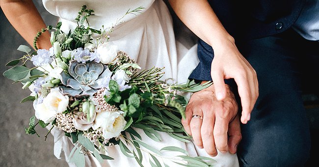 A bride and groom about to hold hands on their wedding day | Photo: Shutterstock