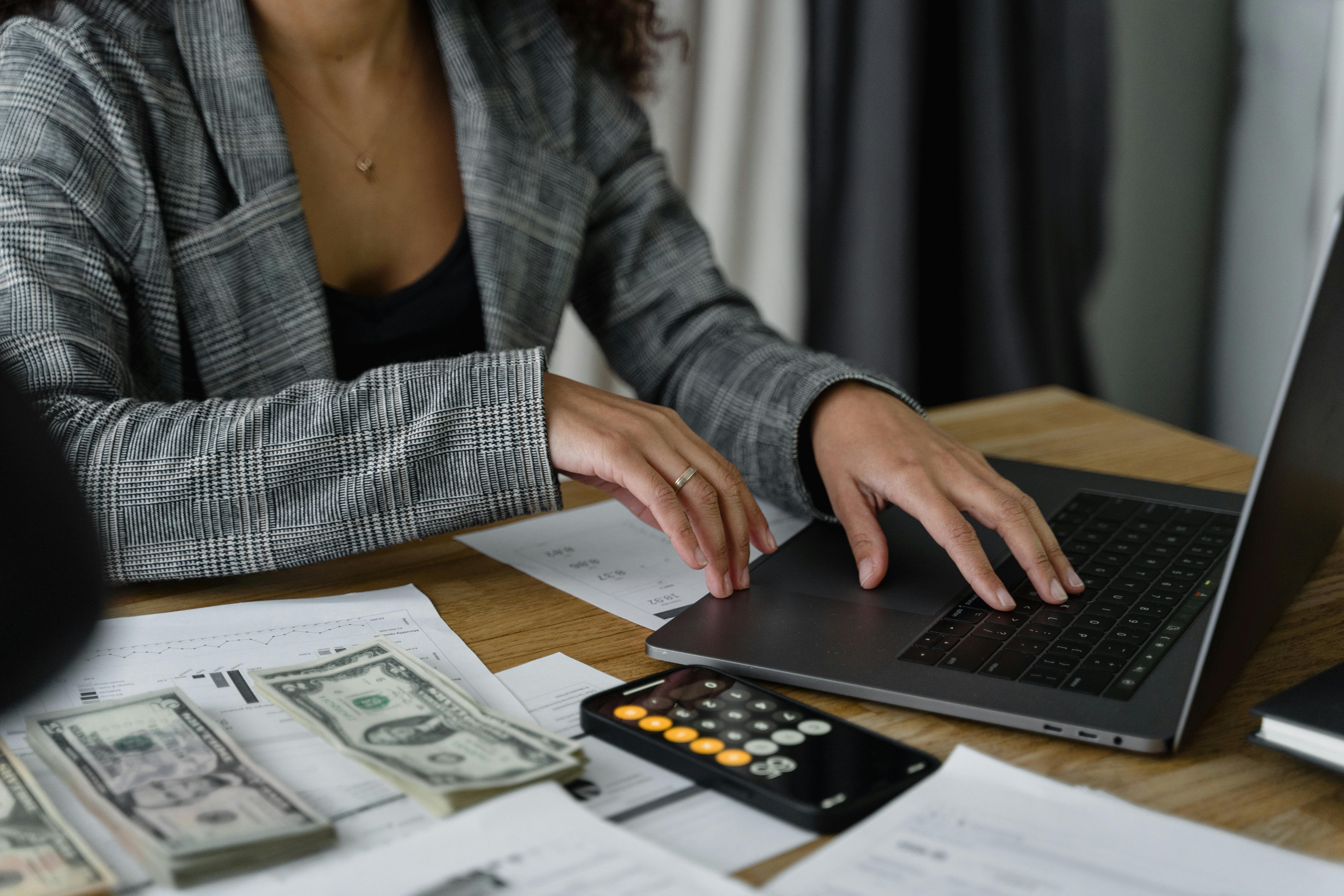 A woman calculating money and saving up | Source: Pexels