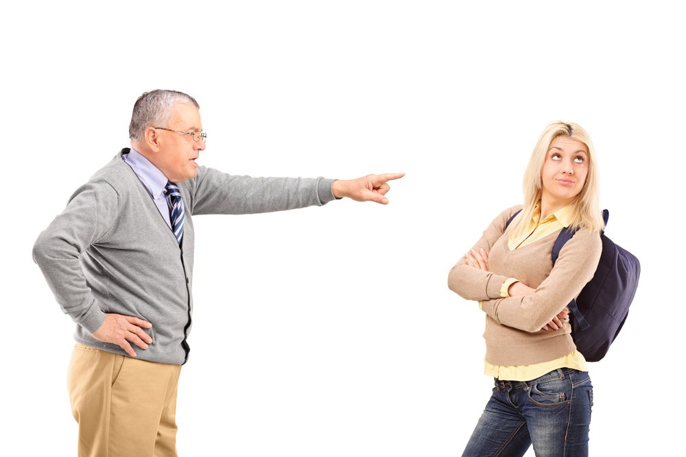 Angry father reprimanding his step-daughter. | Photo: Shutterstock.