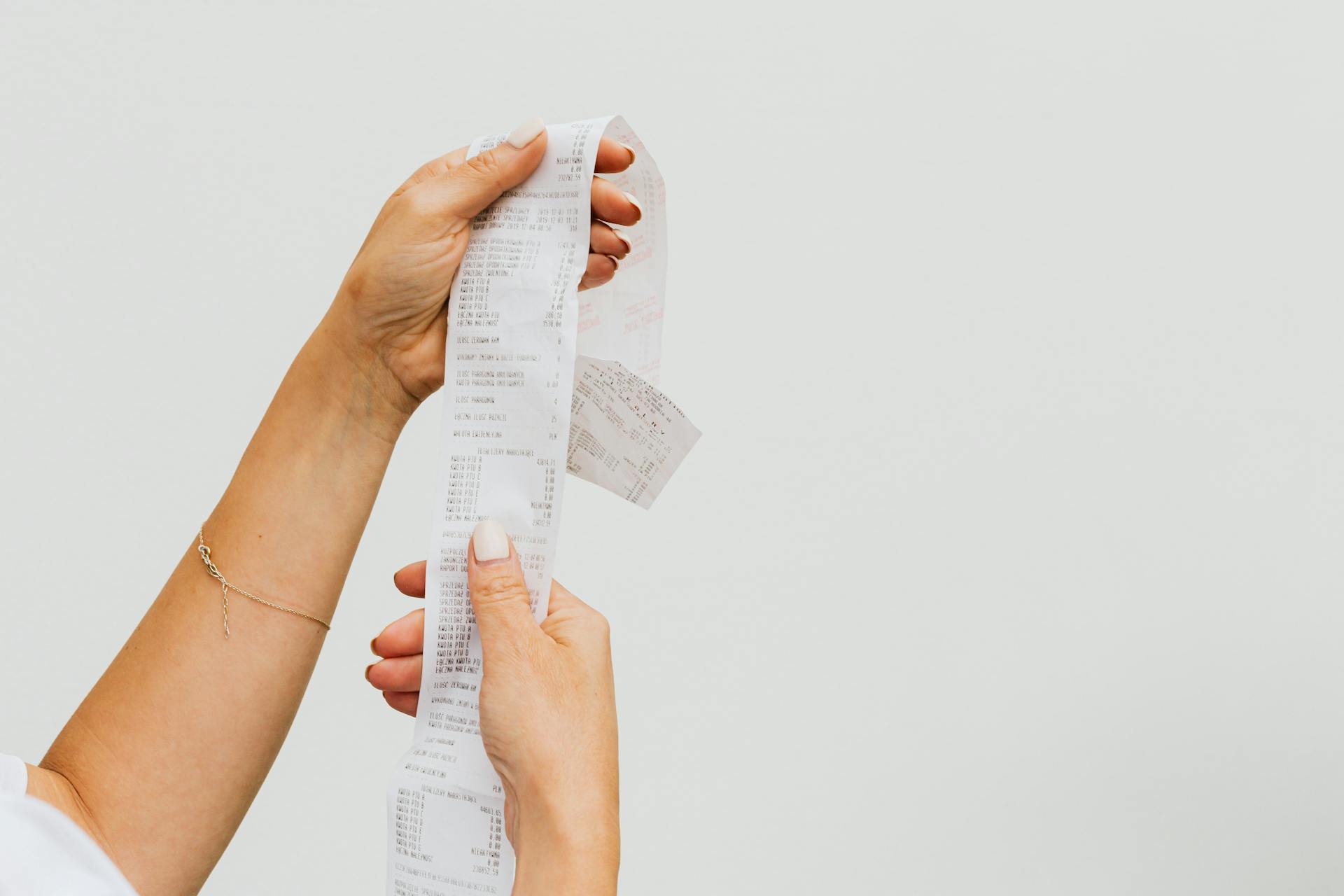 A closeup of a woman holding a grocery receipt | Source: Pexels