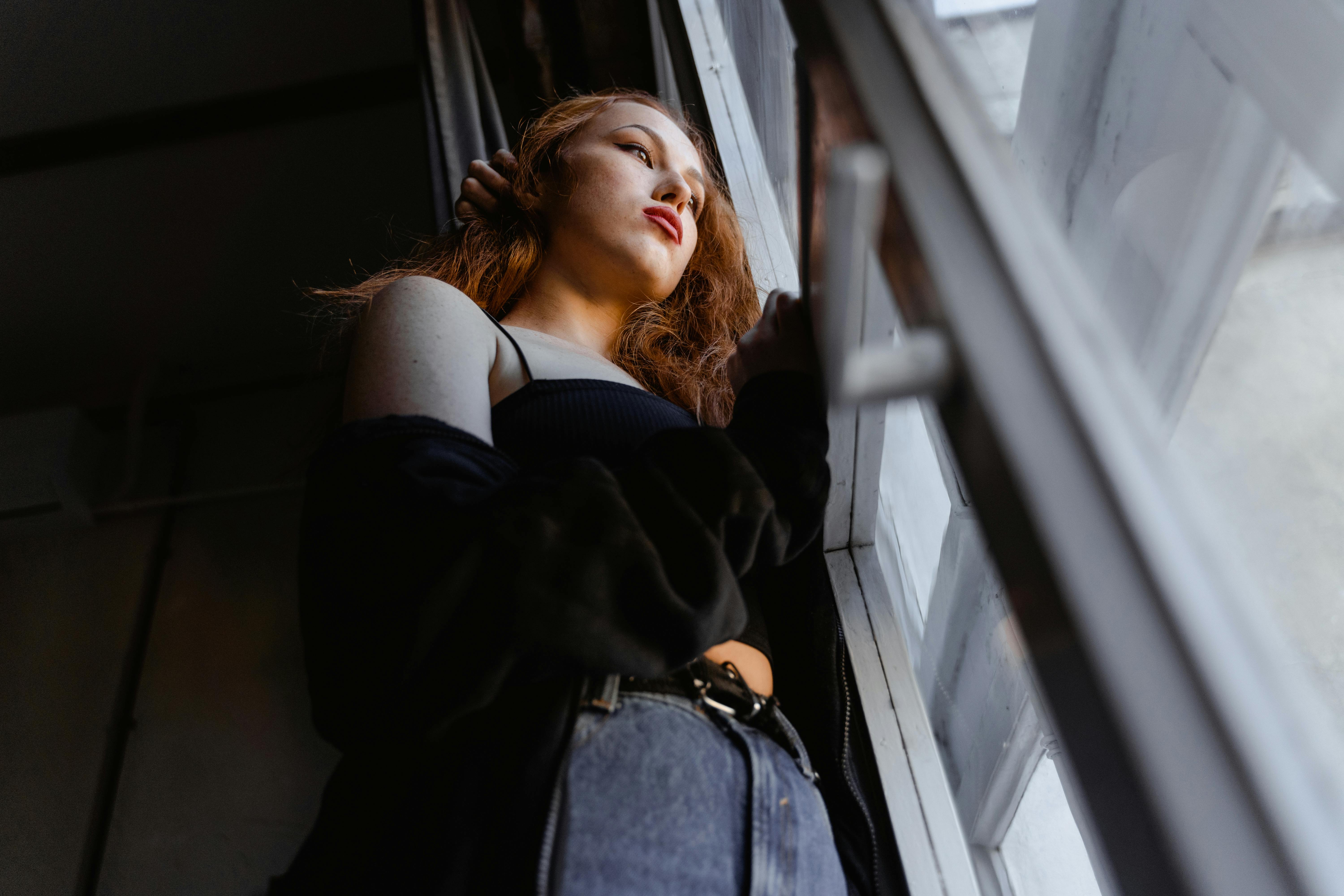 A woman standing by an open door | Source: Pexels