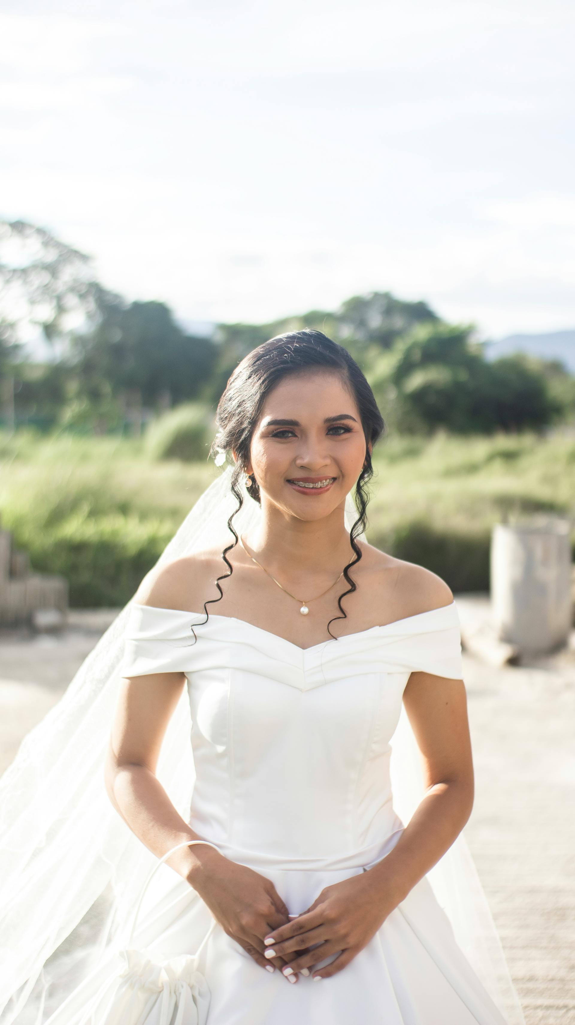 A bride standing outdoors on a sunny day | Source: Pexels