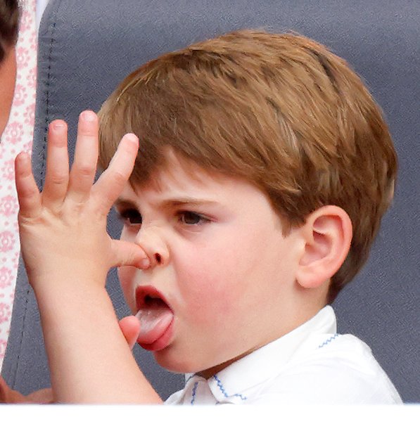 Prince Louis of Cambridge 'thumb's his nose' and sticks his tongue out at his mother Catherine, Duchess of Cambridge as they attend the Platinum Pageant on The Mall on June 5, 2022 in London, England. | Source: Getty Images