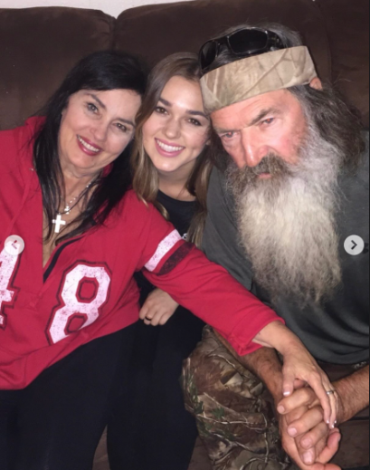 Katy, Sadie, and Phil Robertson lean in for a photo, dated May 2025 | Source: instagram/legitsadierob