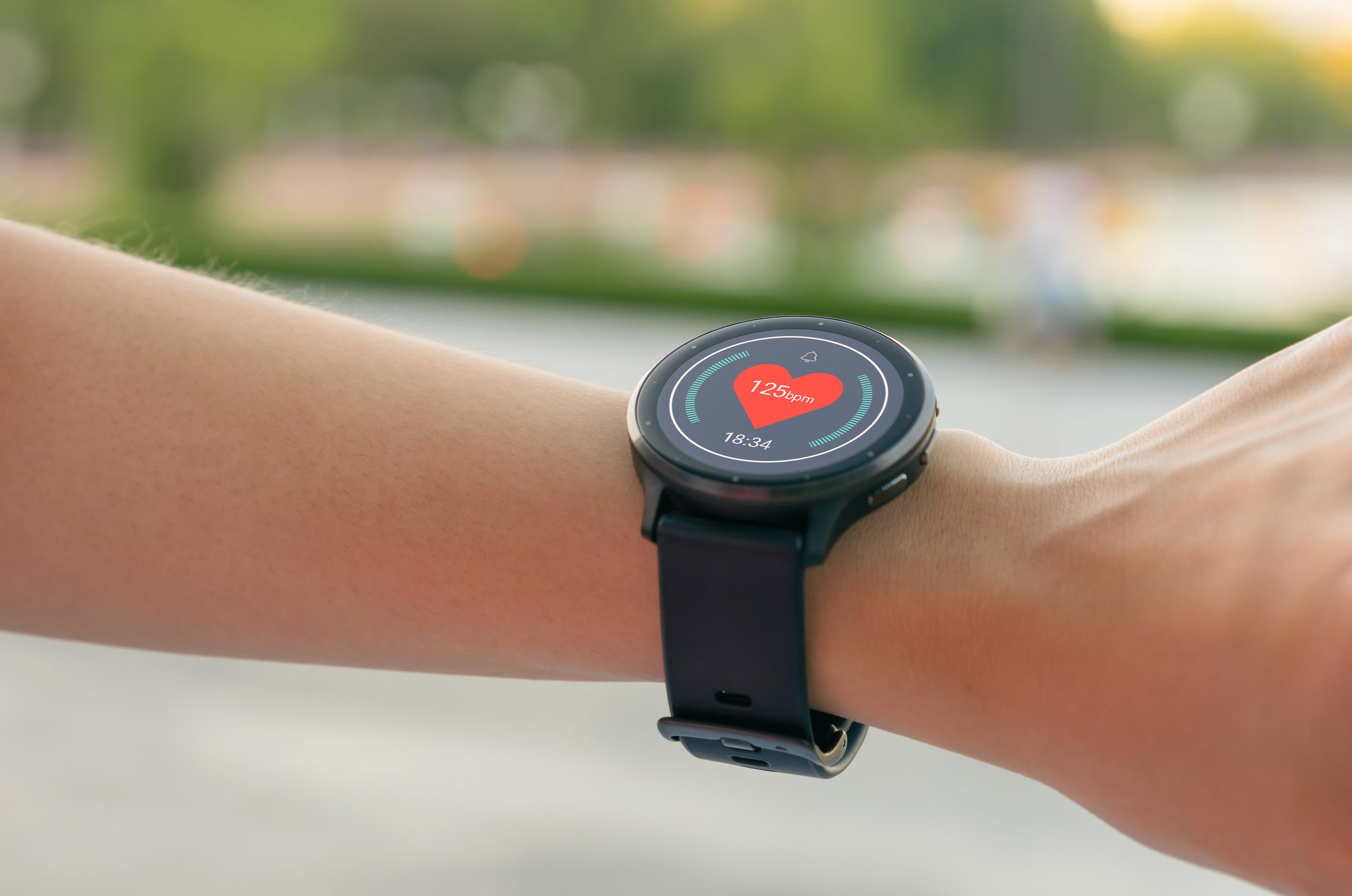 A person wearing a smartwatch checking the heart rate | Source: Shutterstock