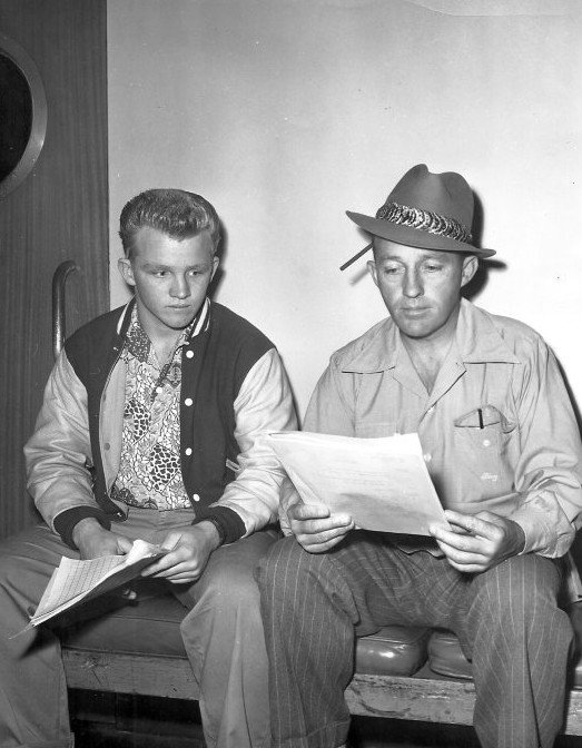 Bing Crosby and Gary Crosby reading a script from Bing's radio program. | Source: Wikimedia Commons