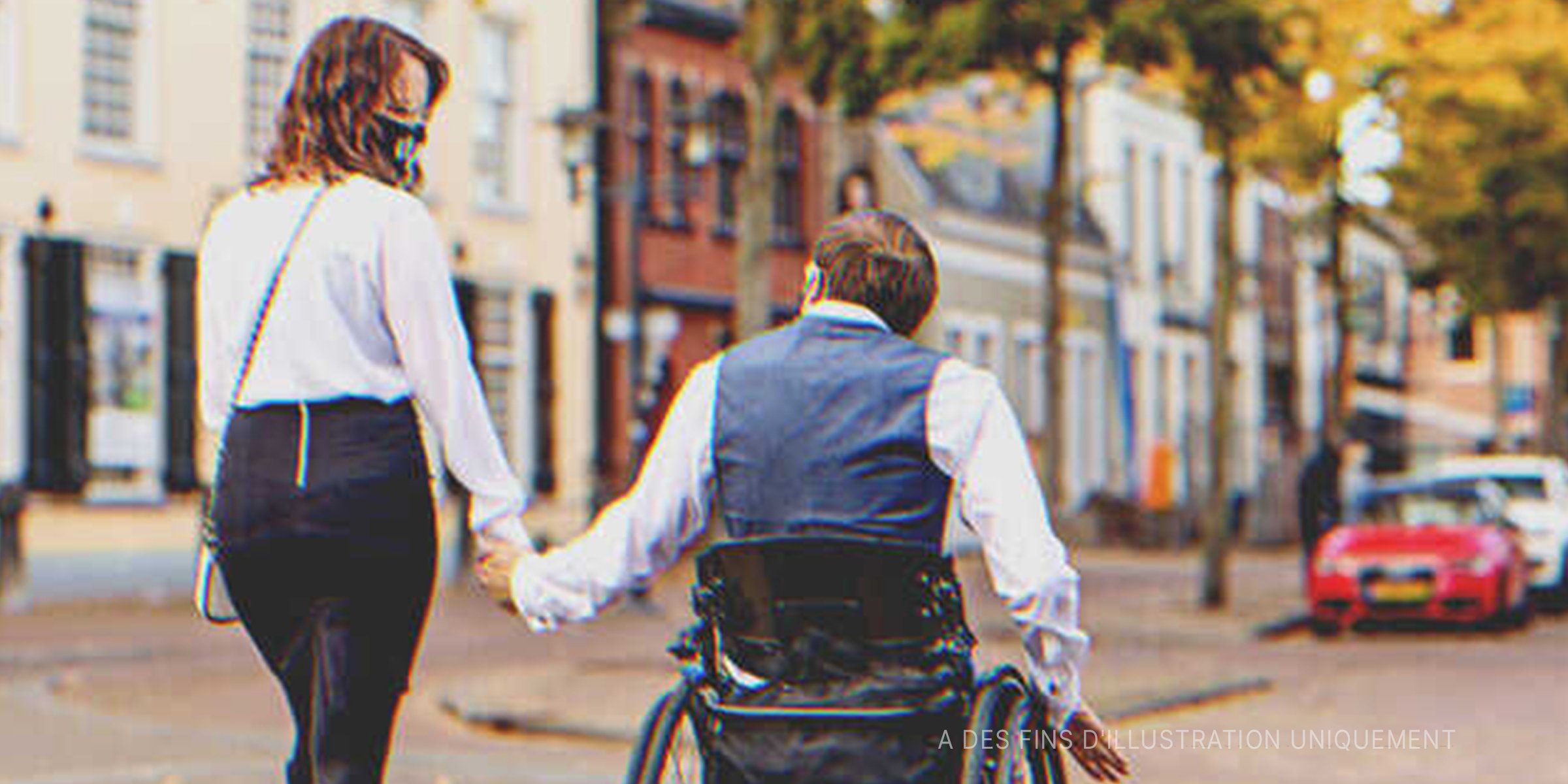 Un homme en fauteuil roulant à l'extérieur avec sa compagne | Source : Getty Images