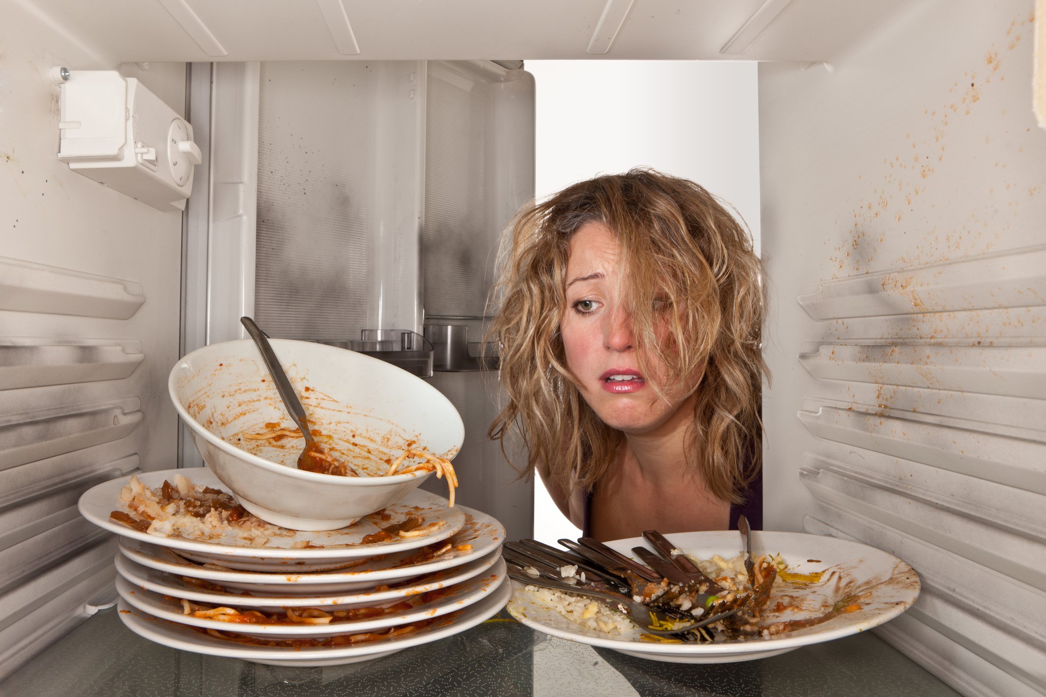 Frau findet schmutziges Geschirr im Kühlschrank I Quelle: Getty Images