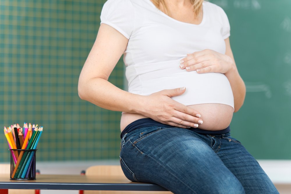 Pregnant teacher at work | Shutterstock