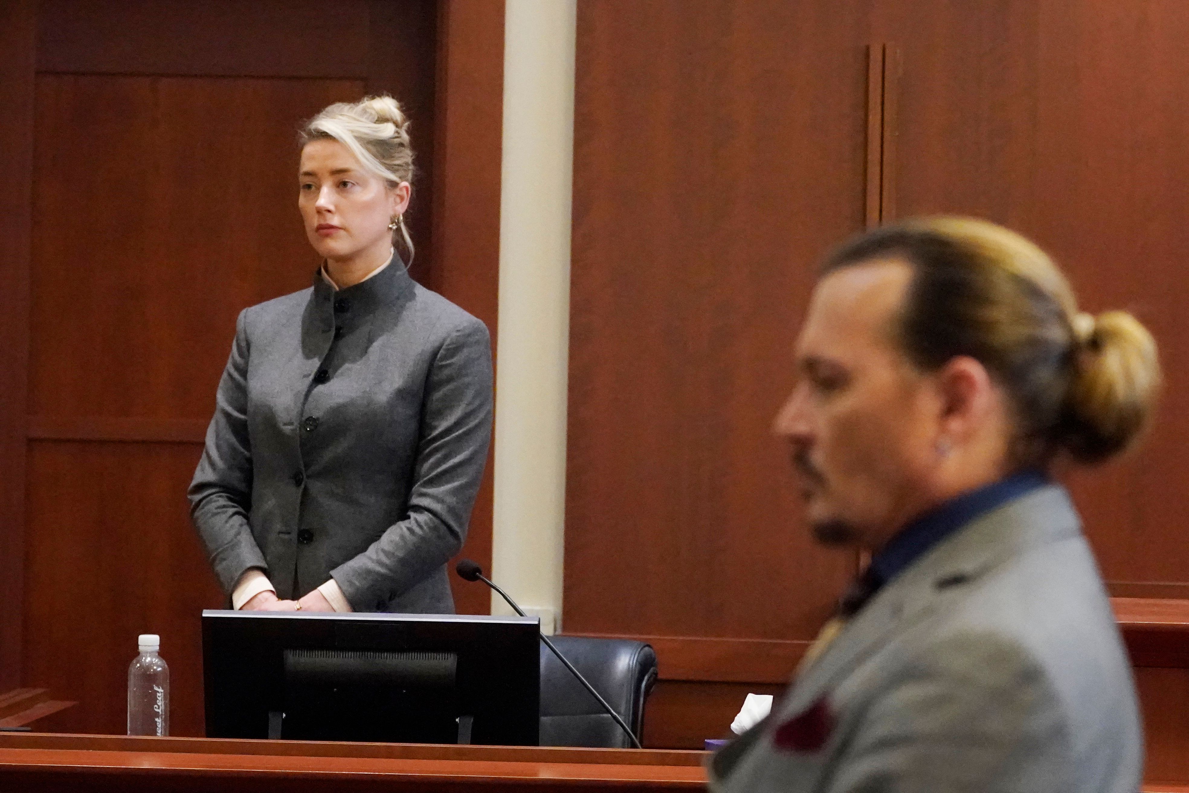 Amber Heard and Johnny Depp watch as the jury leaves the courtroom at the end of the day at the Fairfax County Circuit Courthouse on May 16, 2022, in Fairfax, Virginia. | Source: Getty Images