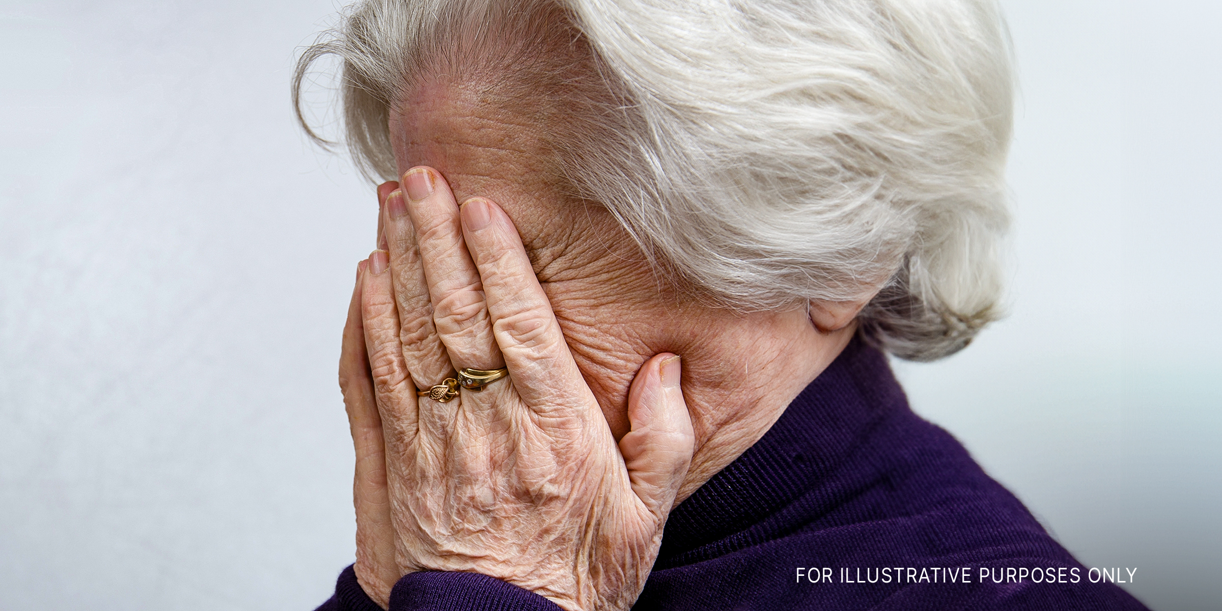 An older woman with her hands on her face | Source: Shutterstock