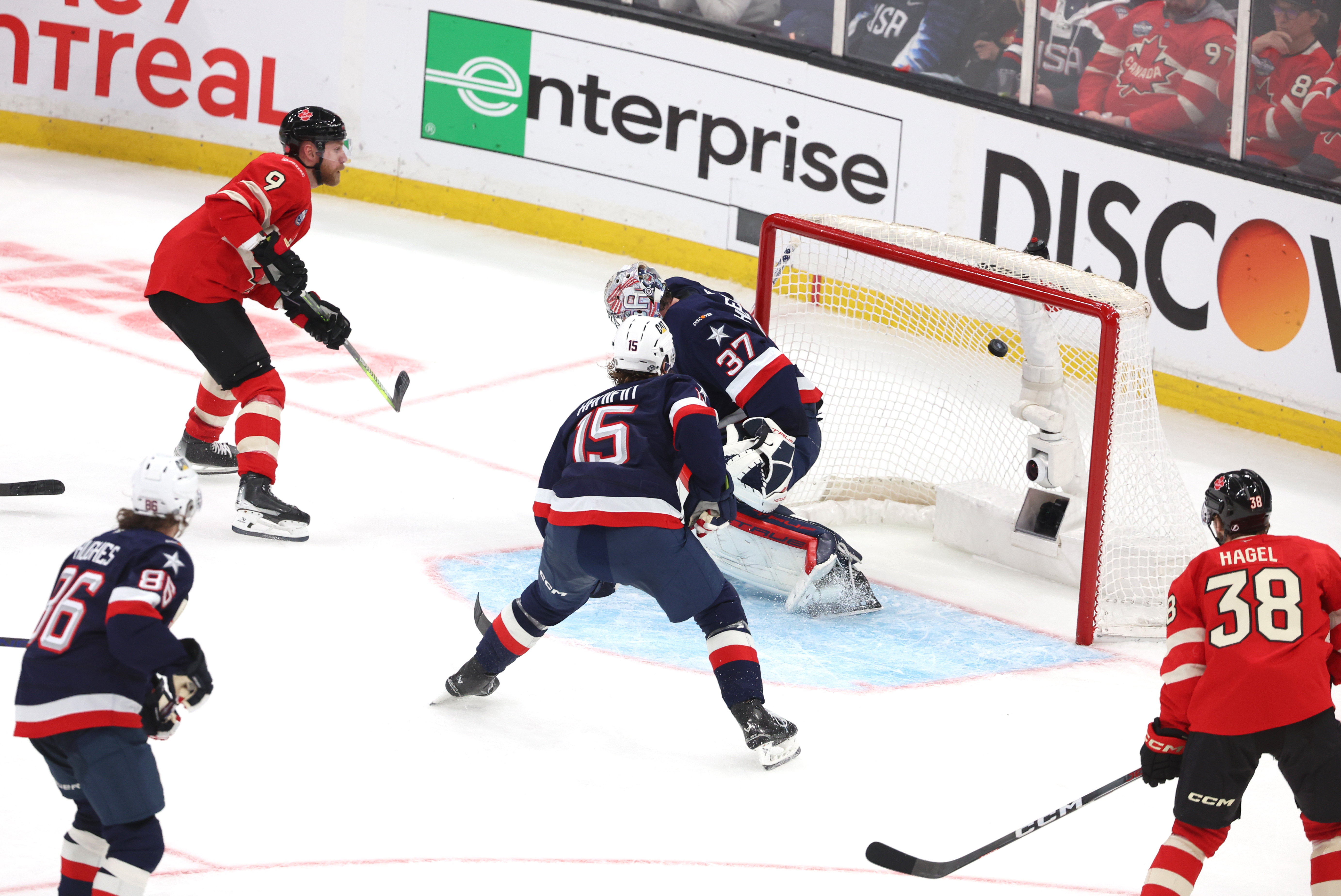 Sam Bennett #9 of Team Canada puts a shot over the shoulder of Connor Hellebuyck #37 of Team United States on February 20, 2025 | Source: Getty Images