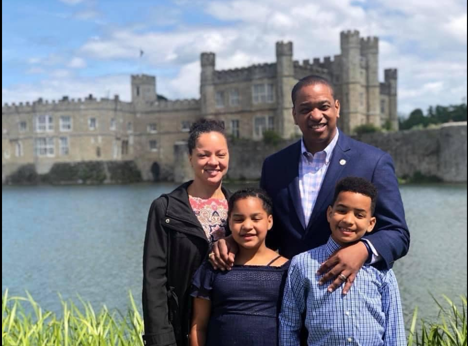 Justin Fairfax, Cerina Fairfax, Cameron Fairfax, and Carys Fairfax pose together outdoors with a castle and water in the background. | Source: Facebook/JustinFairfax