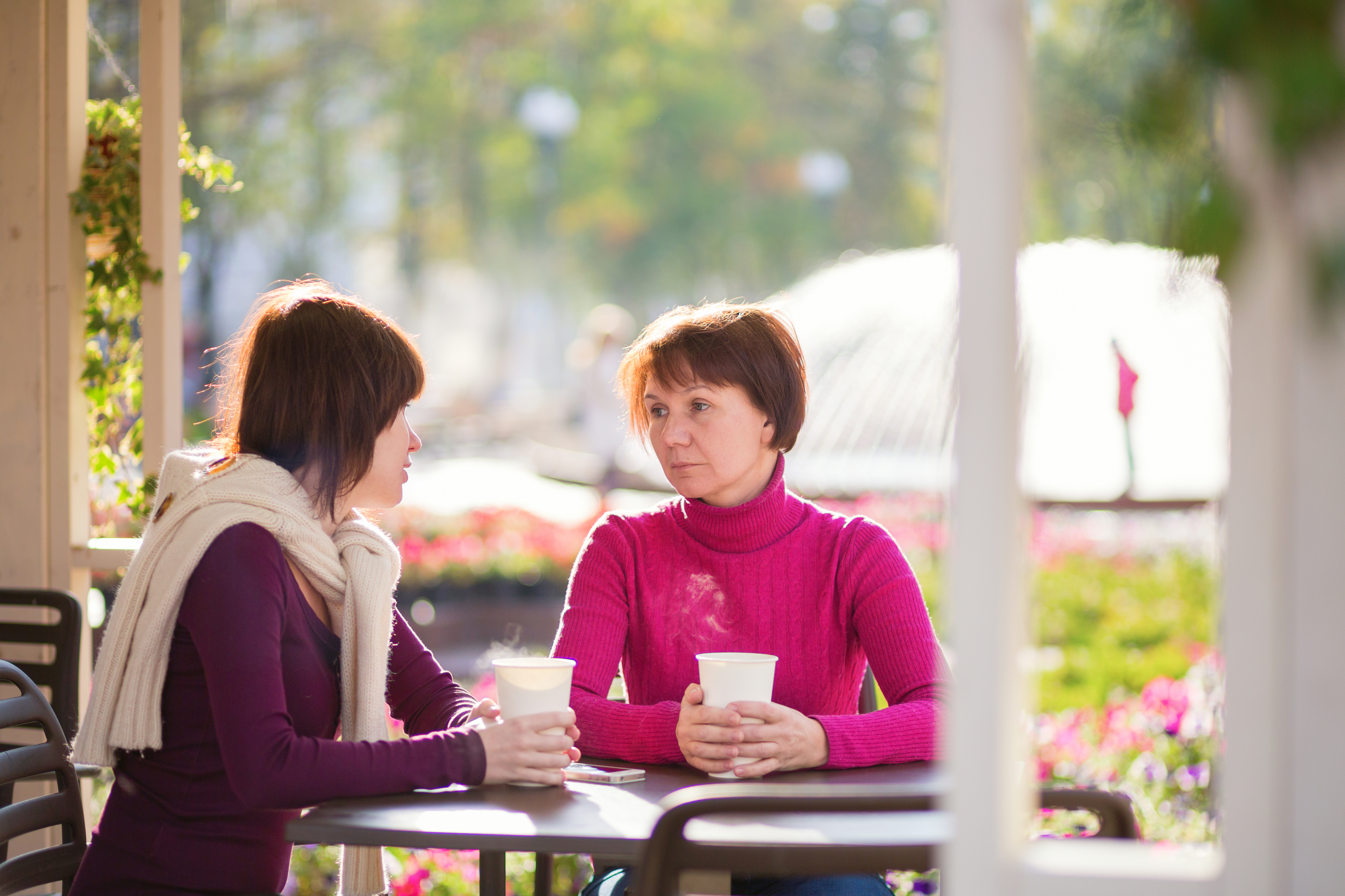 A young woman and an older woman are sitting in a cafe | Source: Shutterstock