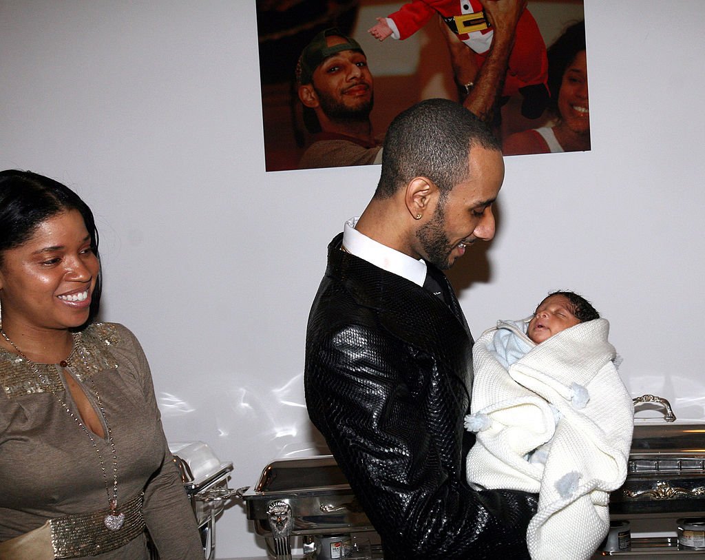 Mashonda smiles at Swizz Beatz as he held their son Kasseem Dean Jr. at their baby Shower on January 15 2007, in New York | Source: Getty Images (Photo by Johnny Nunez/WireImage)