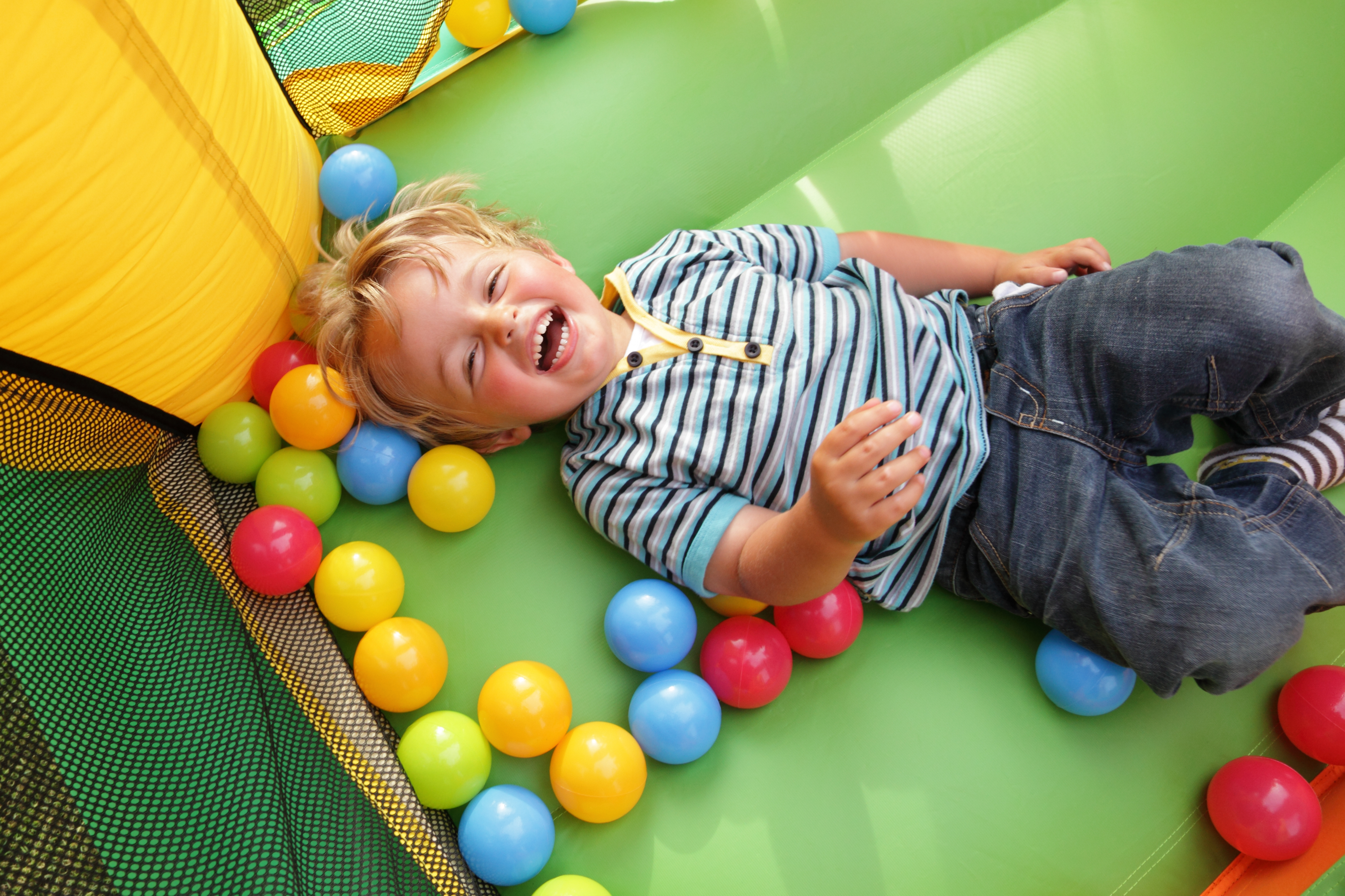 3-years-old boy is lying and laughing | Source: Shutterstock.com
