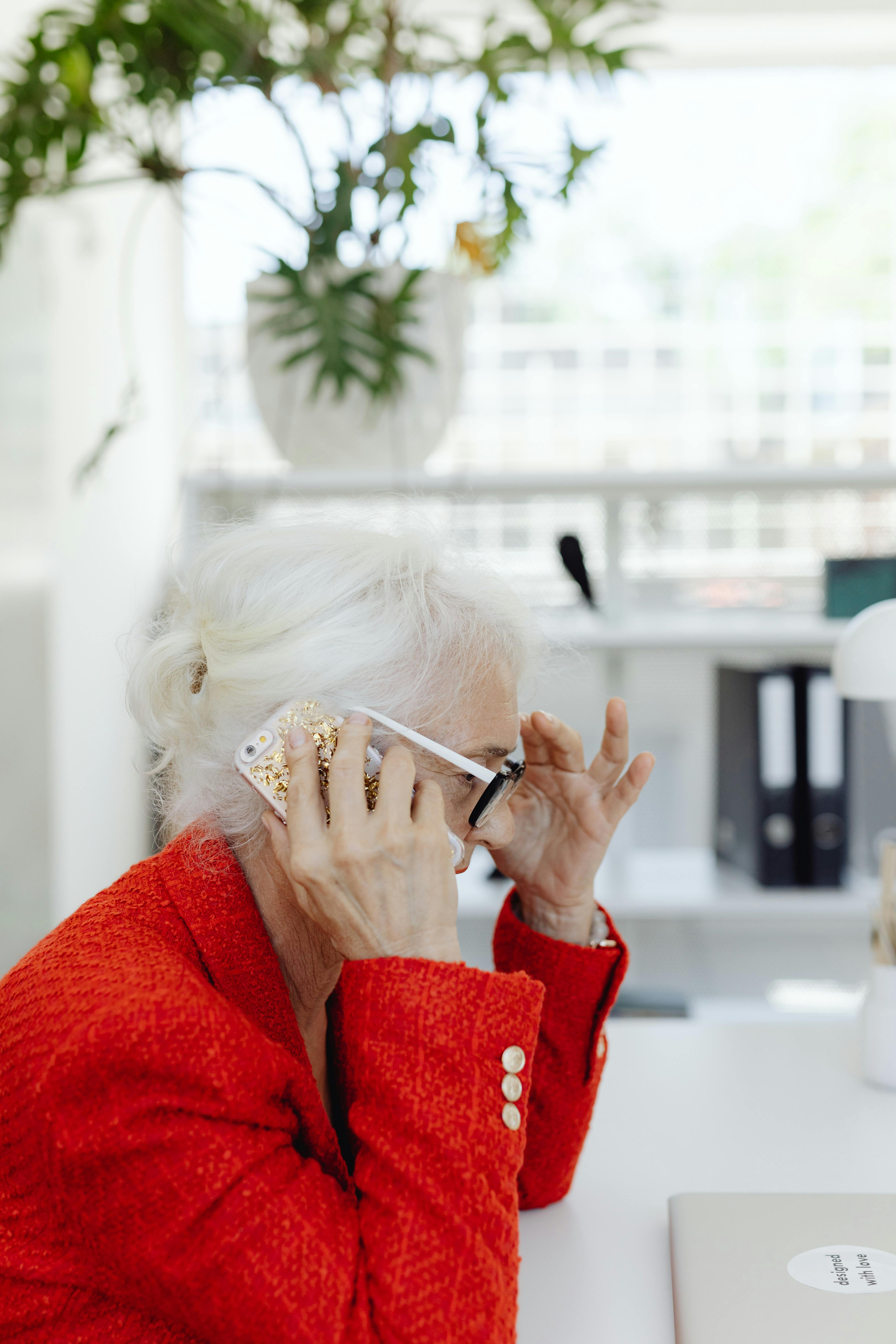 Side-view of a woman holding a phone close to her ear | Source: Pexels