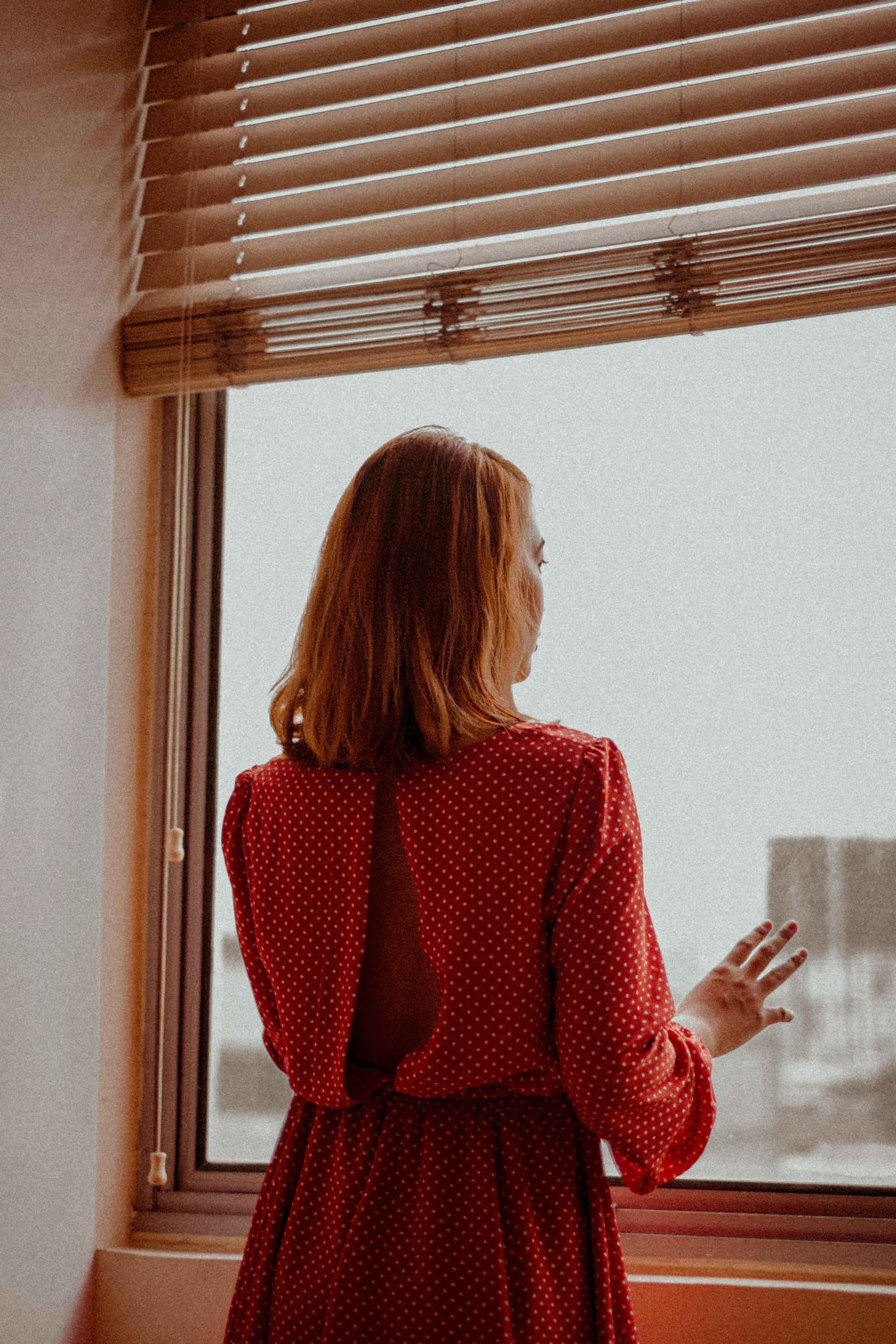 A woman looking out the window | Source: Pexels