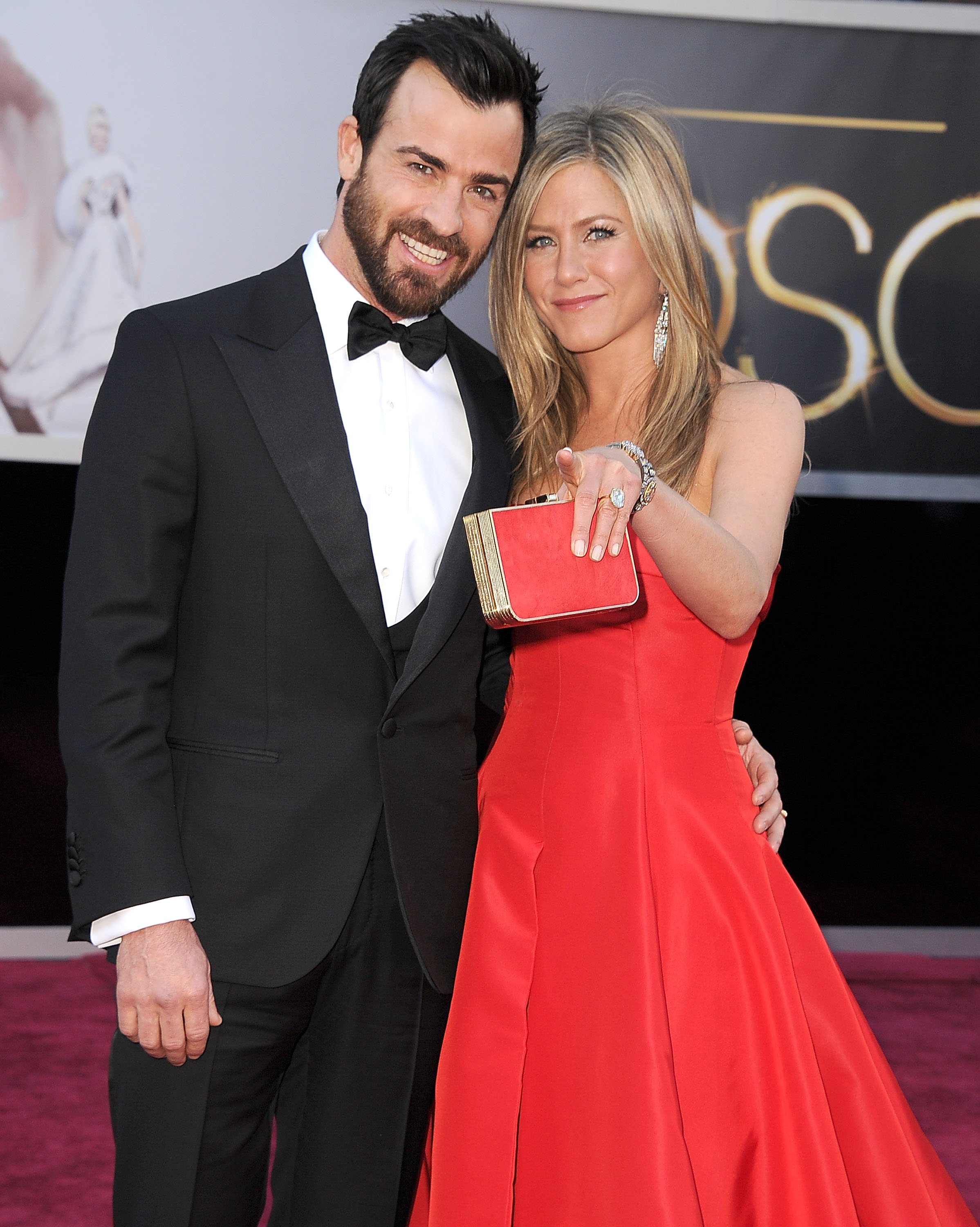 Jennifer Aniston appeared with Justin Theroux at the 85th Annual Academy Awards in February 2013. She wore a bold strapless red gown, holding a matching clutch and smiling beside him on the red carpet.