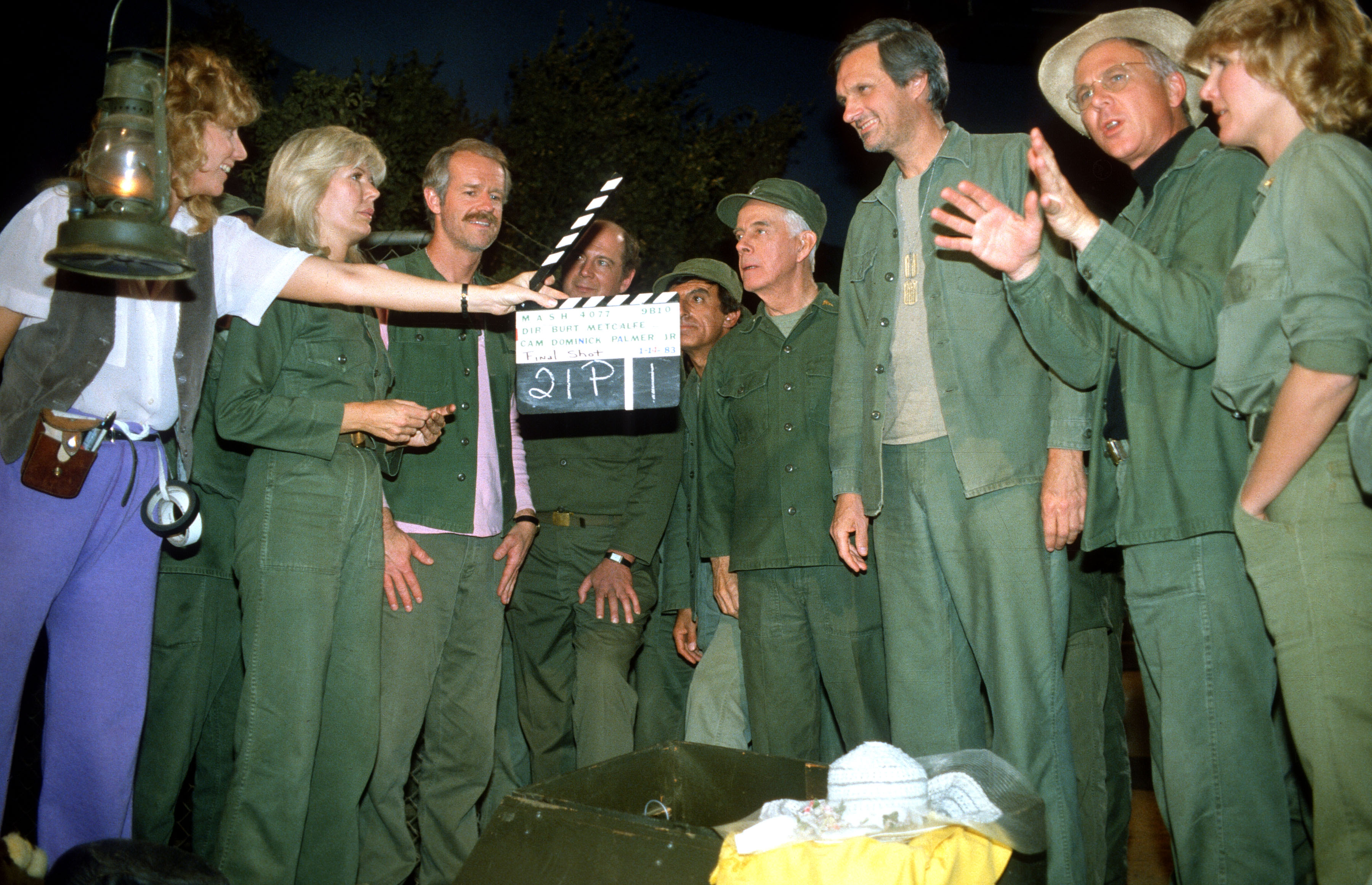 From (L-R): Loretta Swit, Mike Farrell, David Ogden Stiers, Jamie Farr, Harry Morgan, Alan Alda, William Christopher, and Judy Farrell pictured at the Malibu Creek State Park at Fox Ranch on June 18, 1984  in California | Source: Getty Images