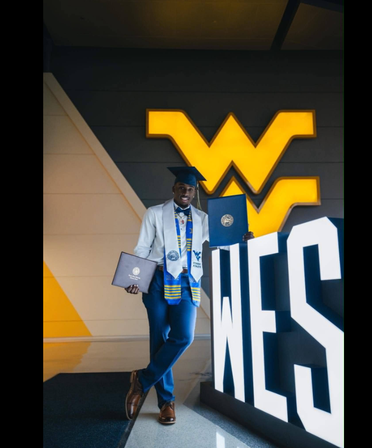 William Davis poses with diploma covers during a graduation photo session at West Virginia University. | Source: Facebook/Michelle Woodall