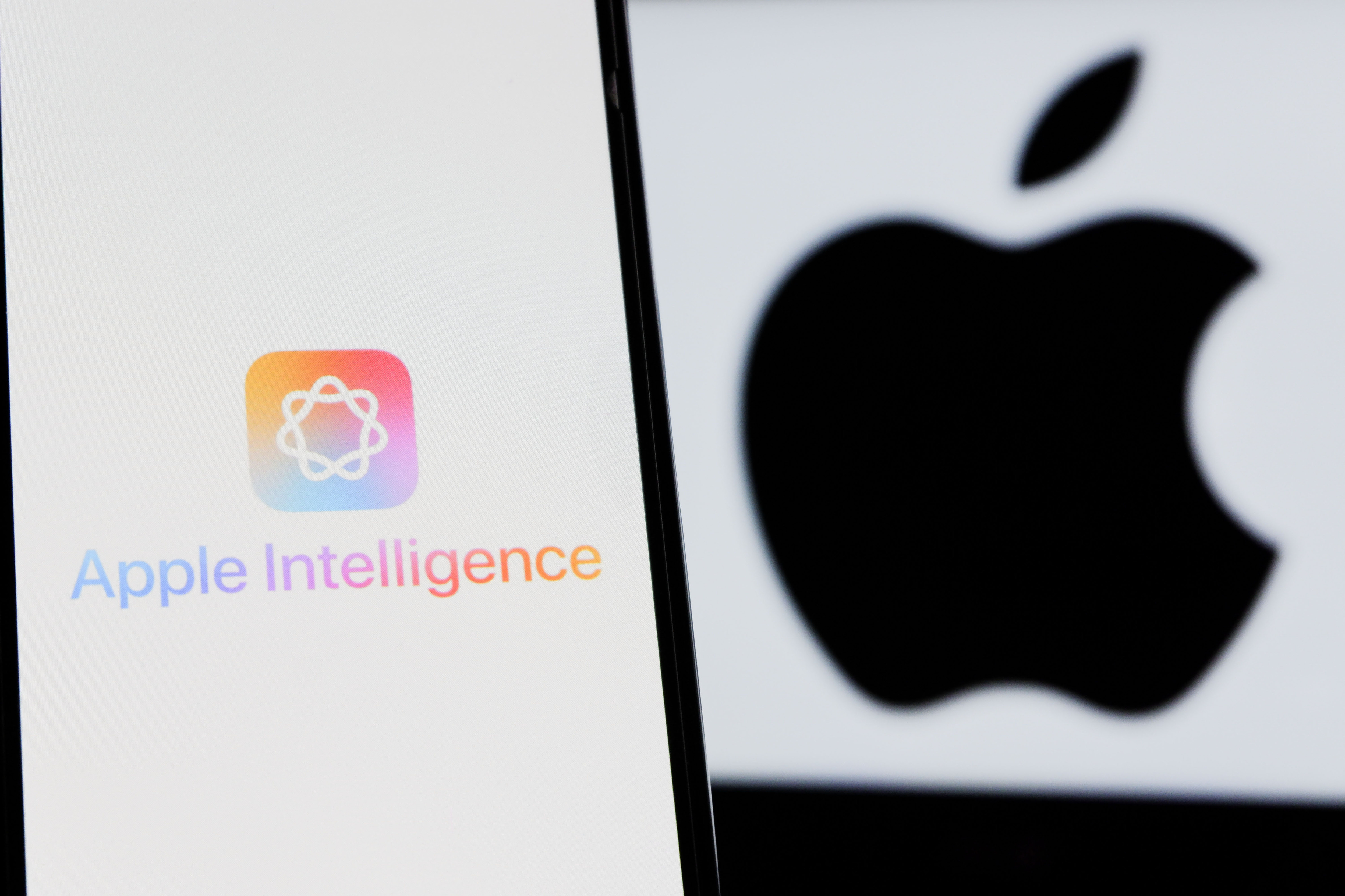 The Apple Intelligence logo is seen displayed on a smartphone with an Apple logo in the background in Indonesia in 2025 | Source: Getty Images